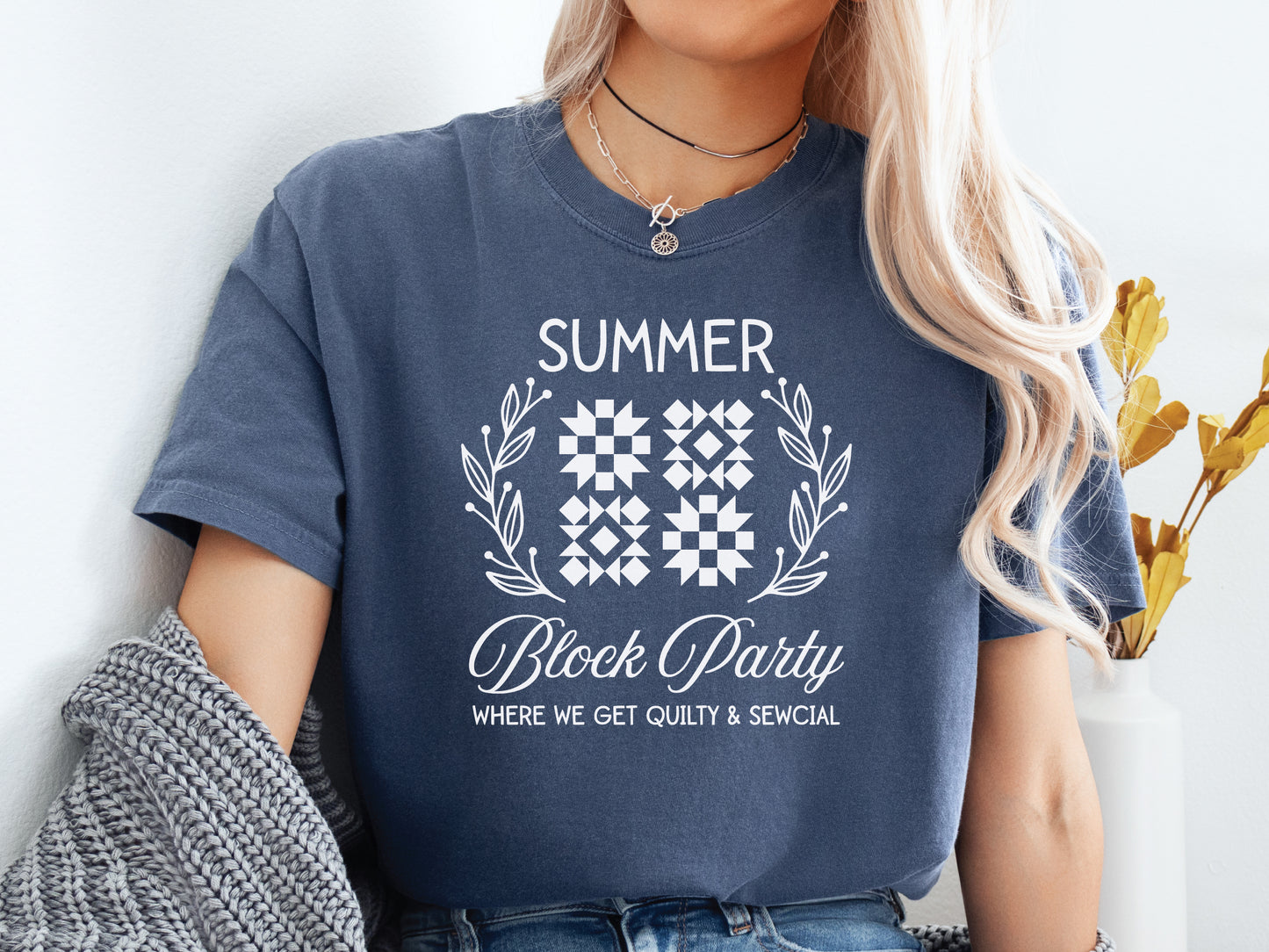 Summer quilt block t-shirt with the phrase “Where We Get Quilty & Sewcial,” a fun gift for quilters and sewists. Perfect for retreats, sew days, and summer stitching sessions.
