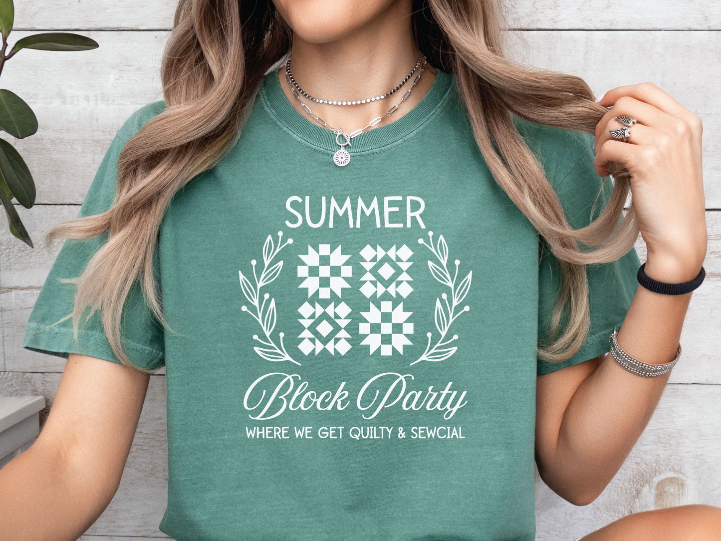 Summer quilt block t-shirt with the phrase “Where We Get Quilty & Sewcial,” a fun gift for quilters and sewists. Perfect for retreats, sew days, and summer stitching sessions.