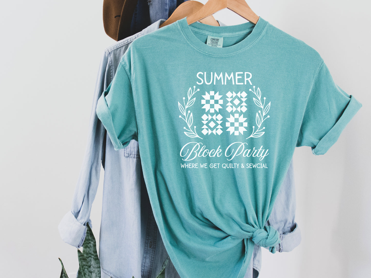 Summer quilt block t-shirt with the phrase “Where We Get Quilty & Sewcial,” a fun gift for quilters and sewists. Perfect for retreats, sew days, and summer stitching sessions.