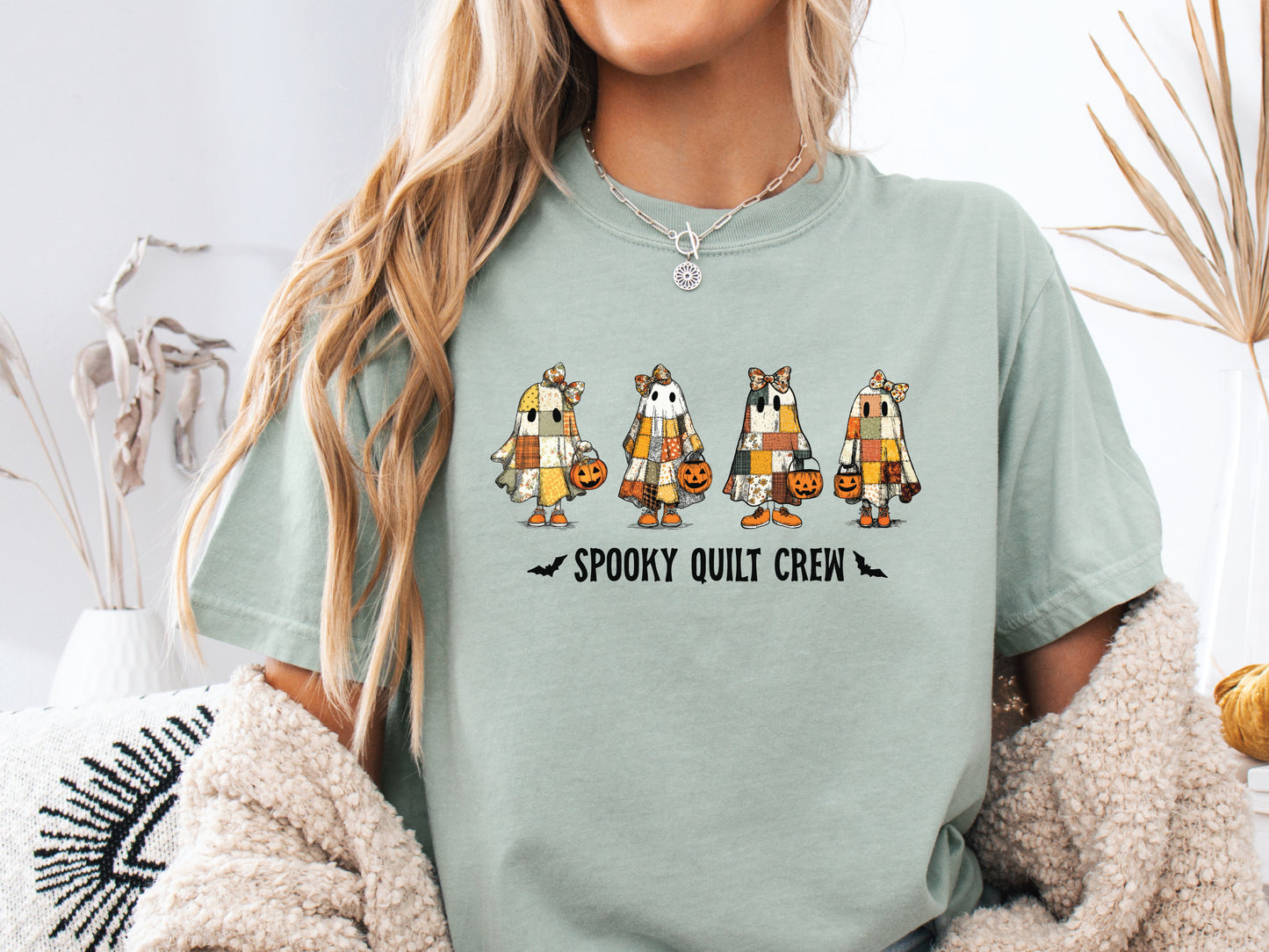 Spooky Quilt Crew Comfort Colors t-shirt from Bee Inspired Tees in Bay (light green), featuring four patchwork ghosts with jack-o’-lanterns and bold text—fun Halloween gift for quilters.