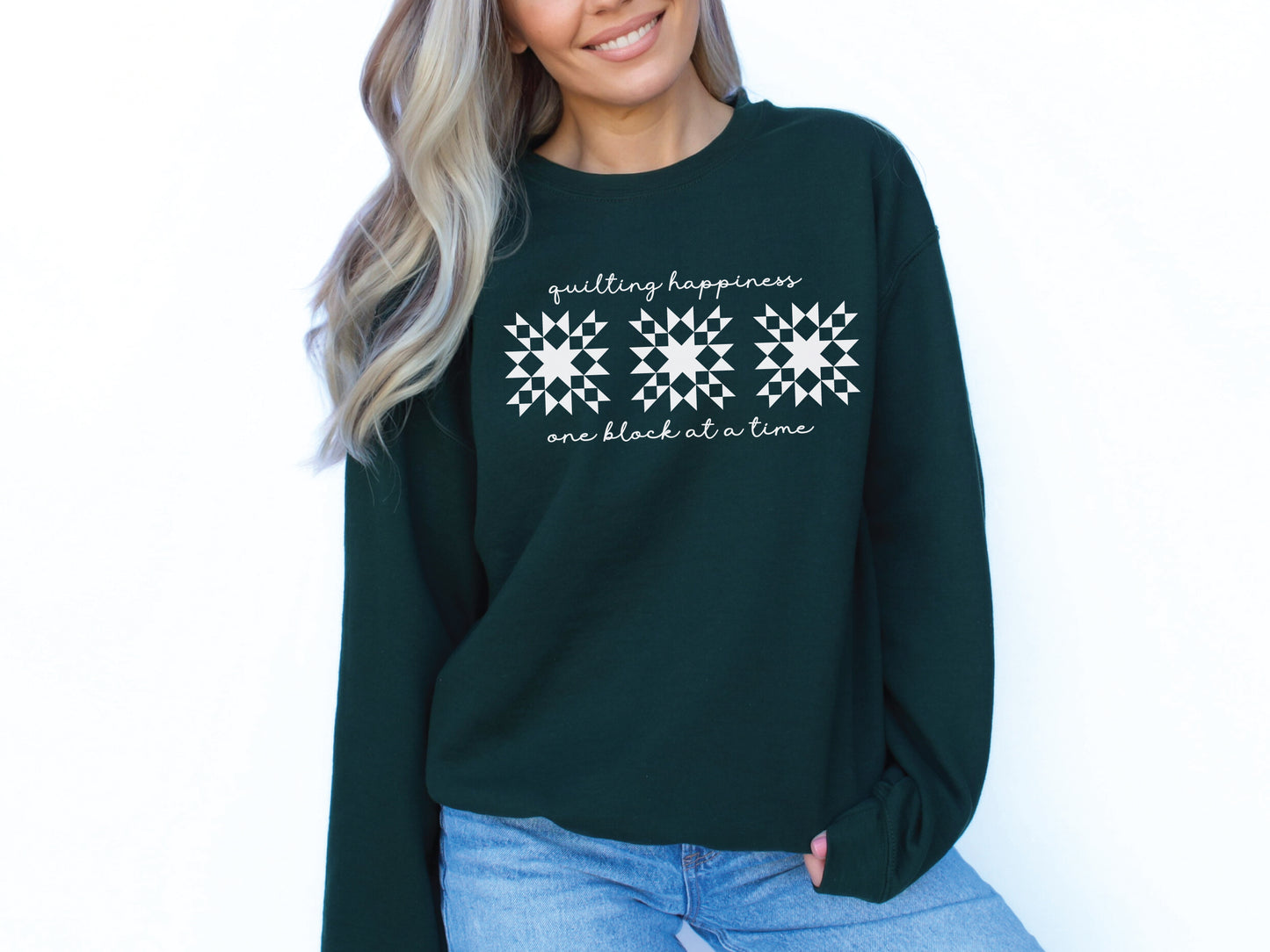 Gildan unisex sweatshirt in Forest Green with the phrase “Quilting Happiness, One Block at a Time,” designed by Bee Inspired Tees. Cozy fall sweatshirt for quilters, ideal for retreats and gifts for quilting lovers.
