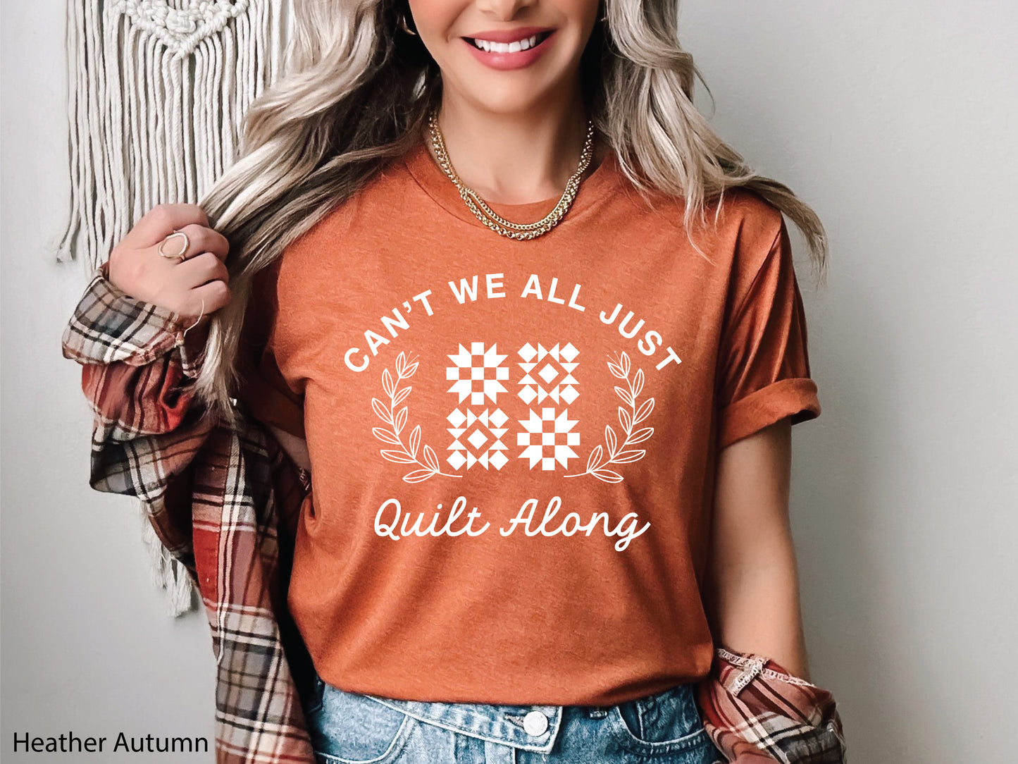 Cozy quilt-themed long sleeve t-shirt with the phrase “Can’t We Just All Quilt Along,” perfect gift for a quilter, ideal for sewing days, quilt retreats, and craft fairs