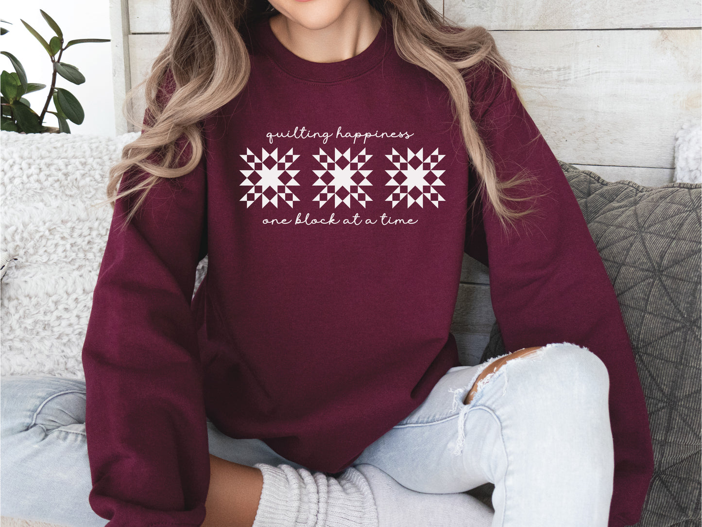 Gildan unisex sweatshirt in Maroon with the phrase “Quilting Happiness, One Block at a Time,” designed by Bee Inspired Tees. Cozy fall sweatshirt for quilters, ideal for retreats and gifts for quilting lovers.