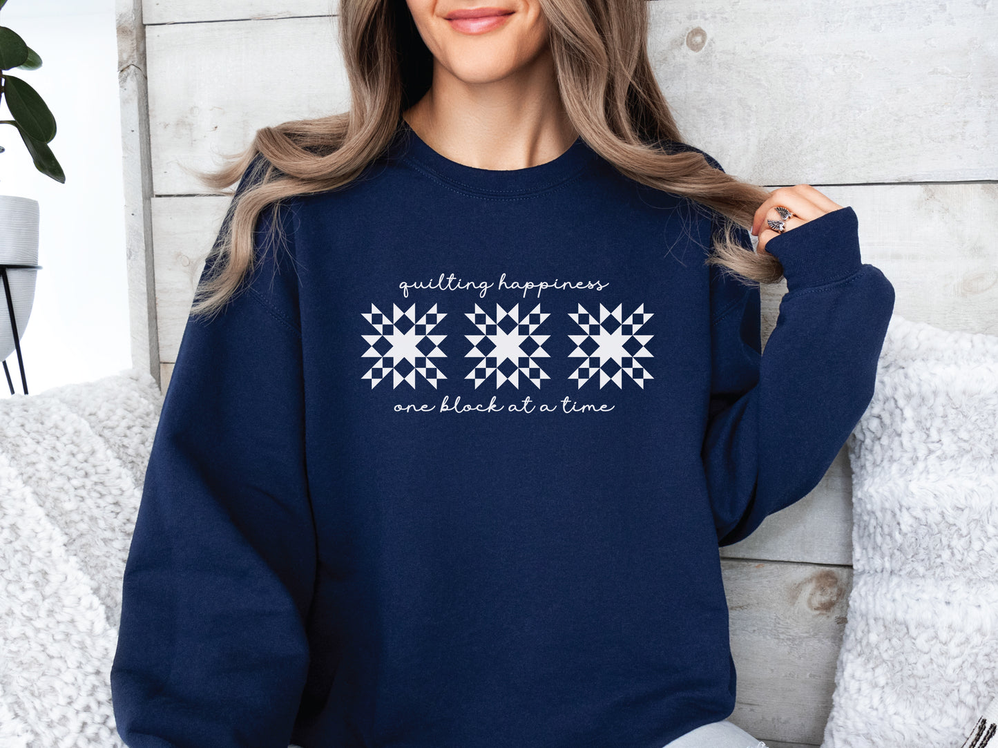 Gildan unisex sweatshirt in Navy with the phrase “Quilting Happiness, One Block at a Time,” designed by Bee Inspired Tees. Cozy fall sweatshirt for quilters, ideal for retreats and gifts for quilting lovers.
