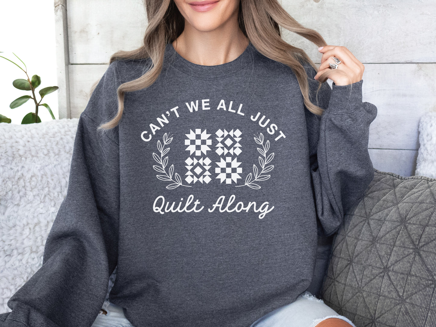 Cozy quilt-themed soft crew Dark Grey sweatshirt with the phrase “Can’t We Just All Quilt Along,” perfect gift for a quilter, ideal for sewing days, quilt retreats, and craft fairs.
