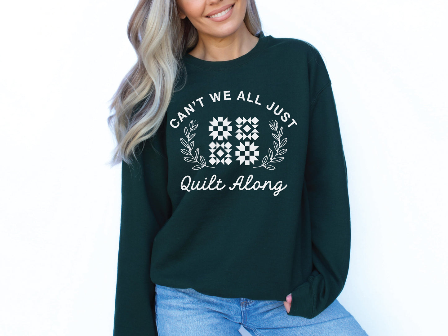 Cozy quilt-themed soft crew Forest Green sweatshirt with the phrase “Can’t We Just All Quilt Along,” perfect gift for a quilter, ideal for sewing days, quilt retreats, and craft fairs.