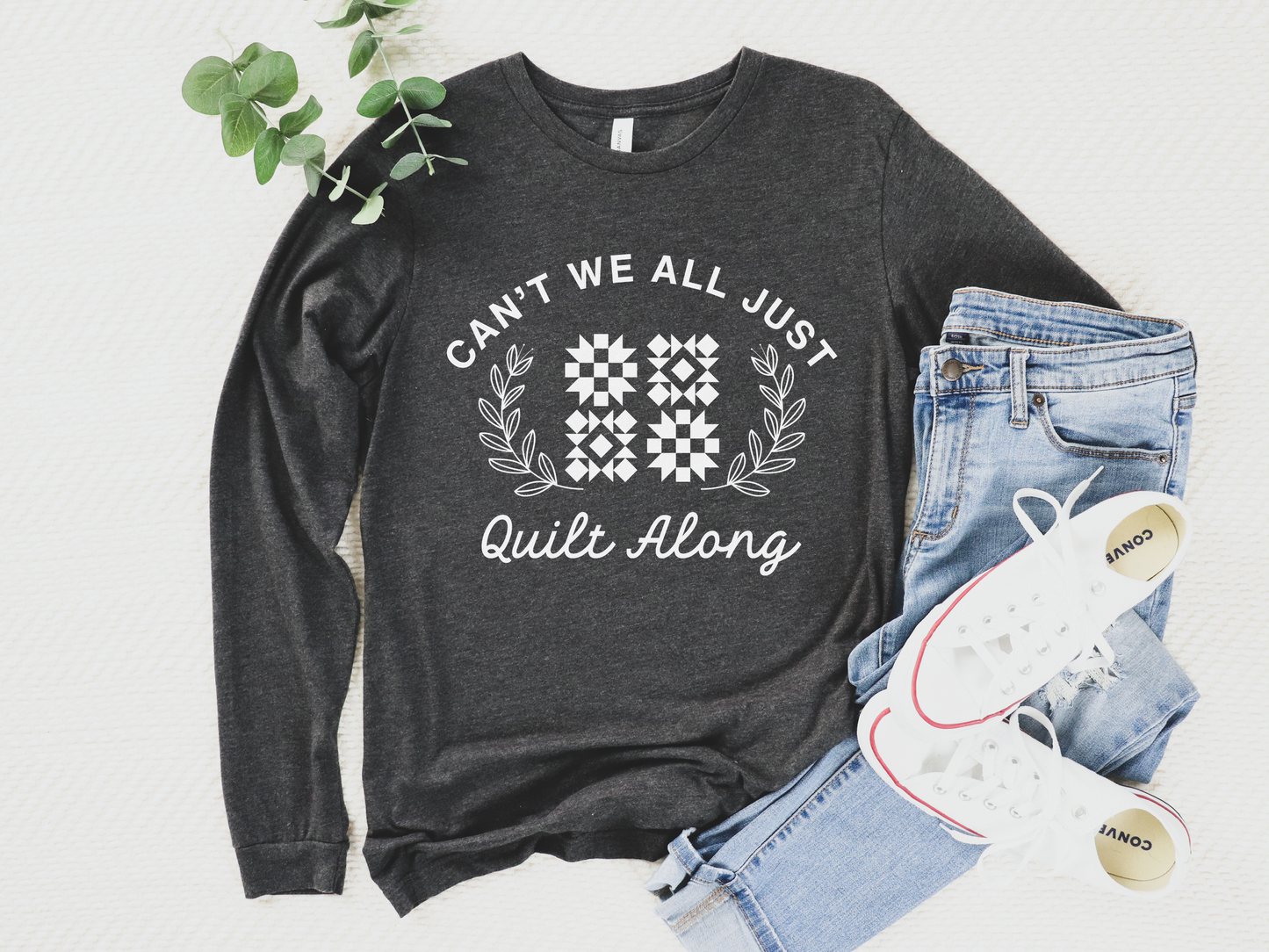 Cozy quilt-themed long sleeve Dark Grey t-shirt with the phrase “Can’t We Just All Quilt Along,” perfect gift for a quilter, ideal for sewing days, quilt retreats, and craft fairs.