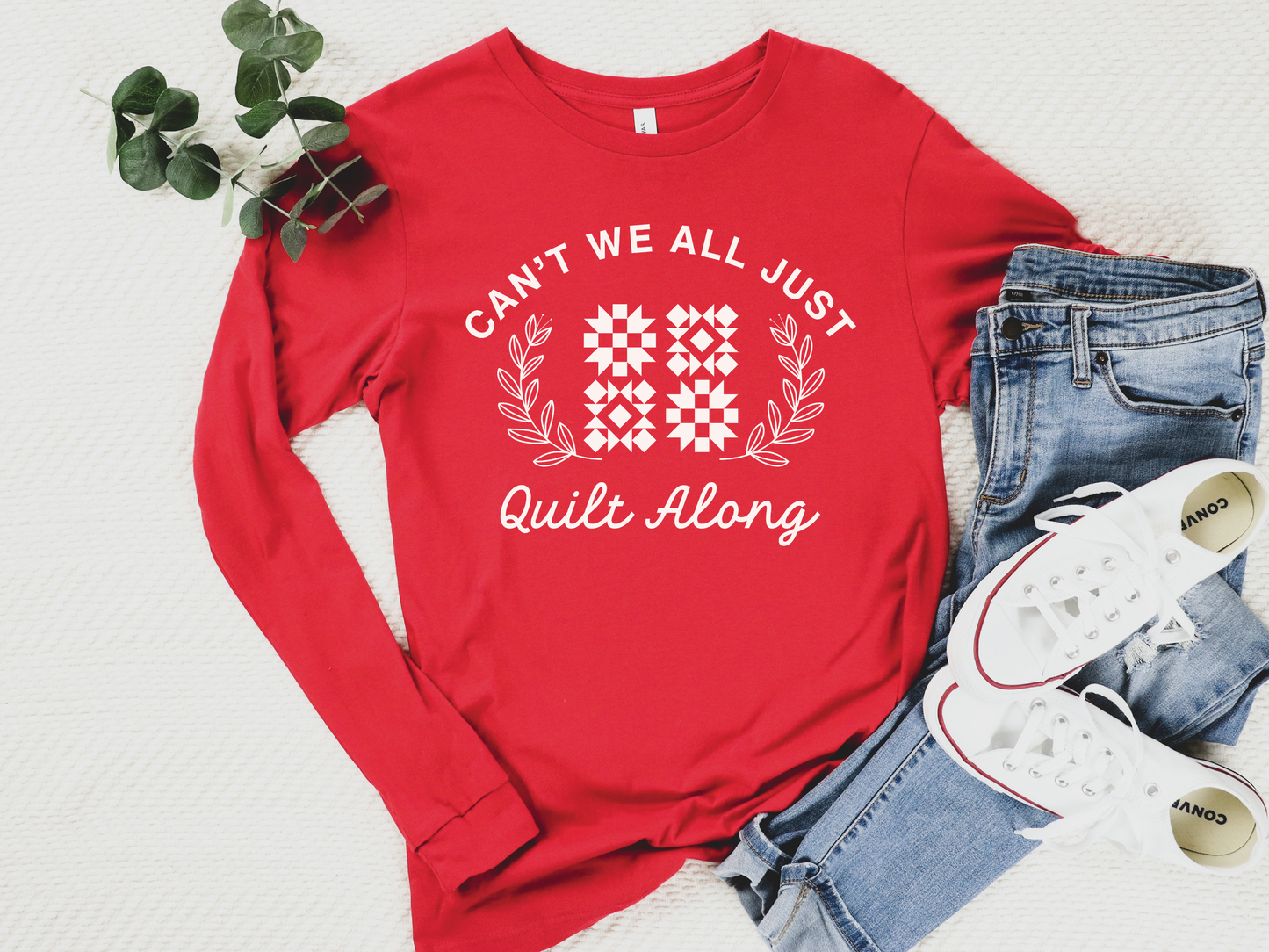 Cozy quilt-themed long sleeve Red t-shirt with the phrase “Can’t We Just All Quilt Along,” perfect gift for a quilter, ideal for sewing days, quilt retreats, and craft fairs.