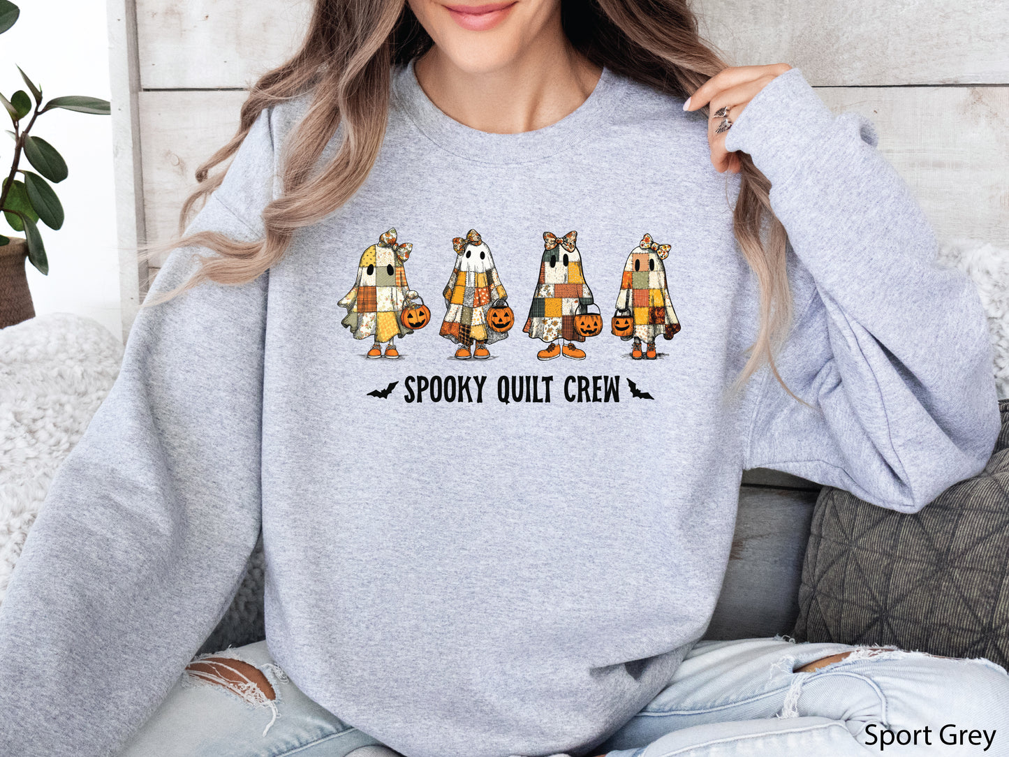 Spooky Quilt Crew sweatshirt from Bee Inspired Tees in the color Sport Grey, featuring four patchwork ghosts with jack-o’-lanterns and bold text—fun Halloween gift for quilters.