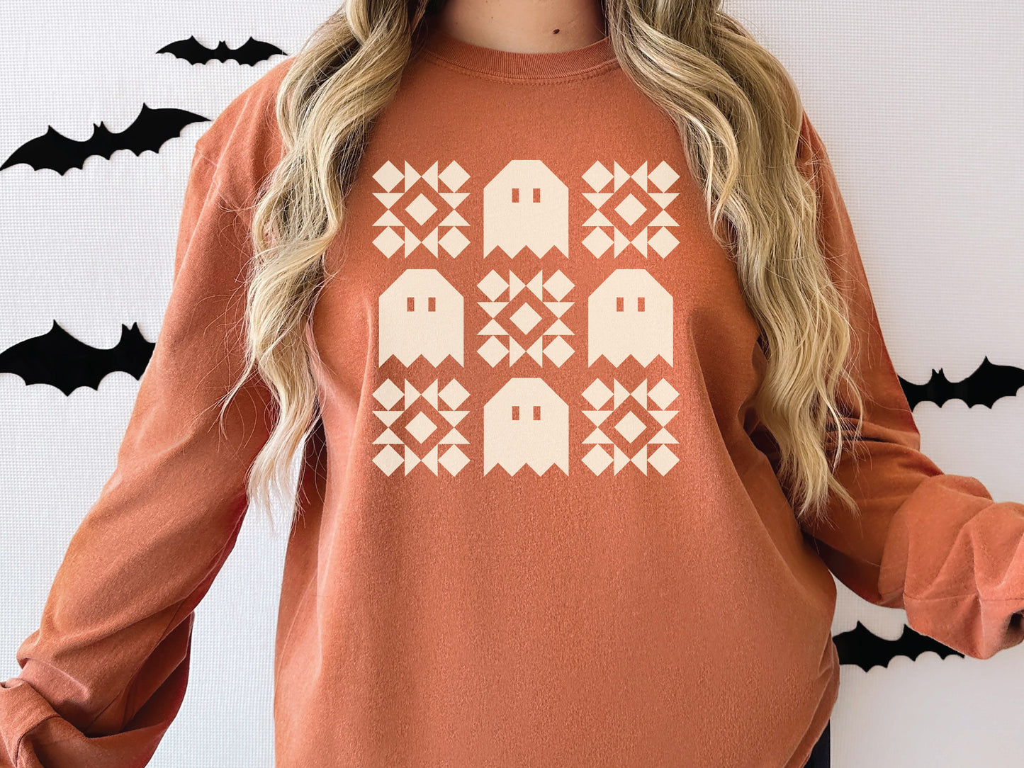 Halloween quilt long sleeve Comfort Colors t-shirt in Yam orange with spooky ghost quilt blocks—perfect fall gift for quilters.
