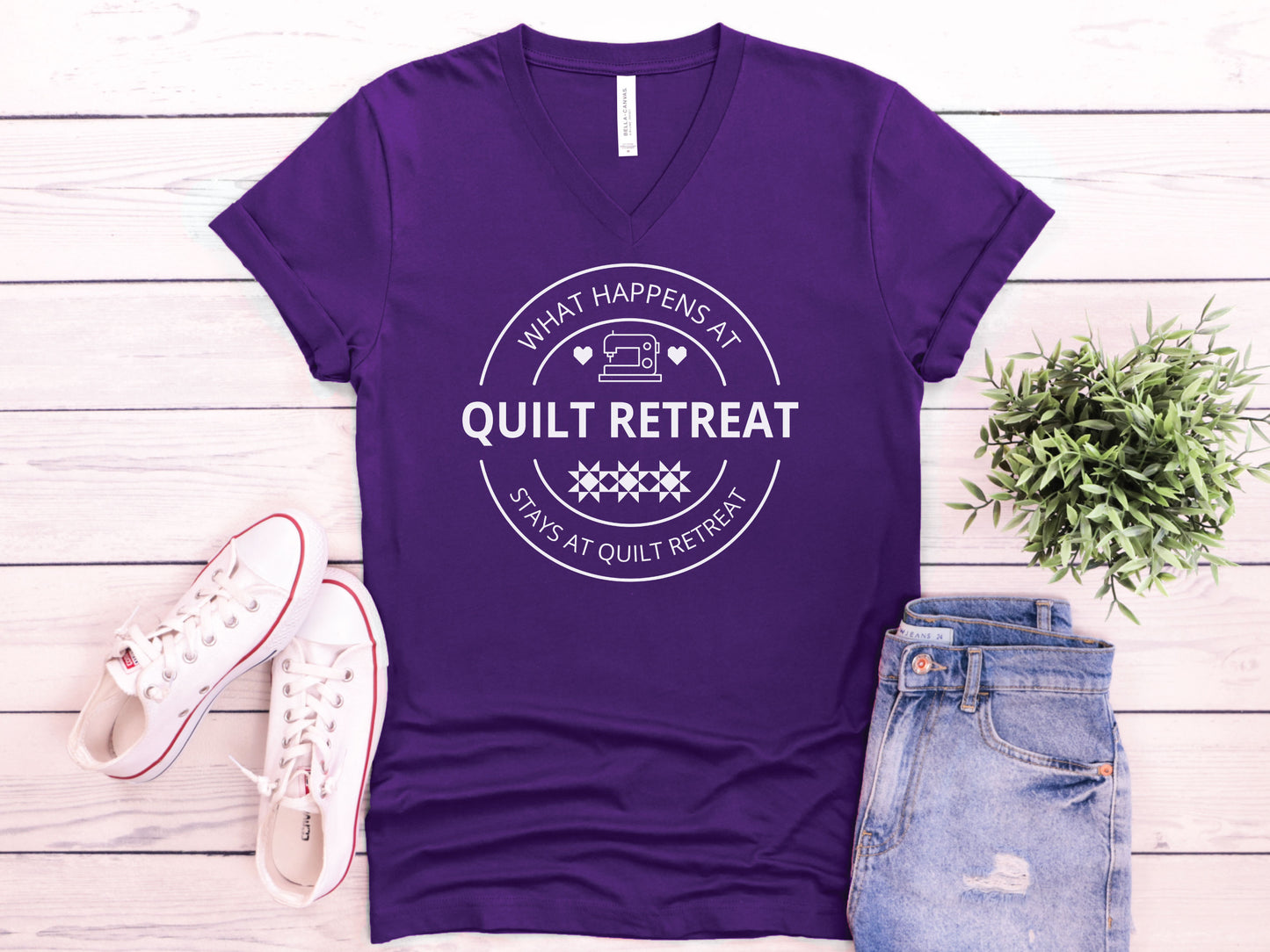 What Happens at Quilt Retreat t-shirt in black, fun quilting-themed gift for quilters and stitching crews. Purple Bella V-Neck Shirt.