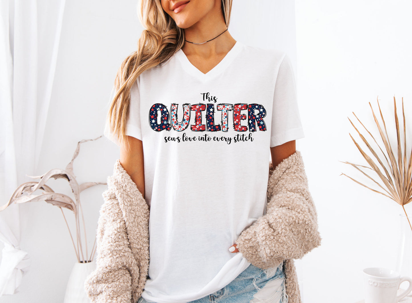 Patriotic quilting t-shirt with the phrase “This Quilter Sews Love Into Every Stitch” in red, white, and blue patchwork lettering, perfect for celebrating America’s 250th Anniversary.