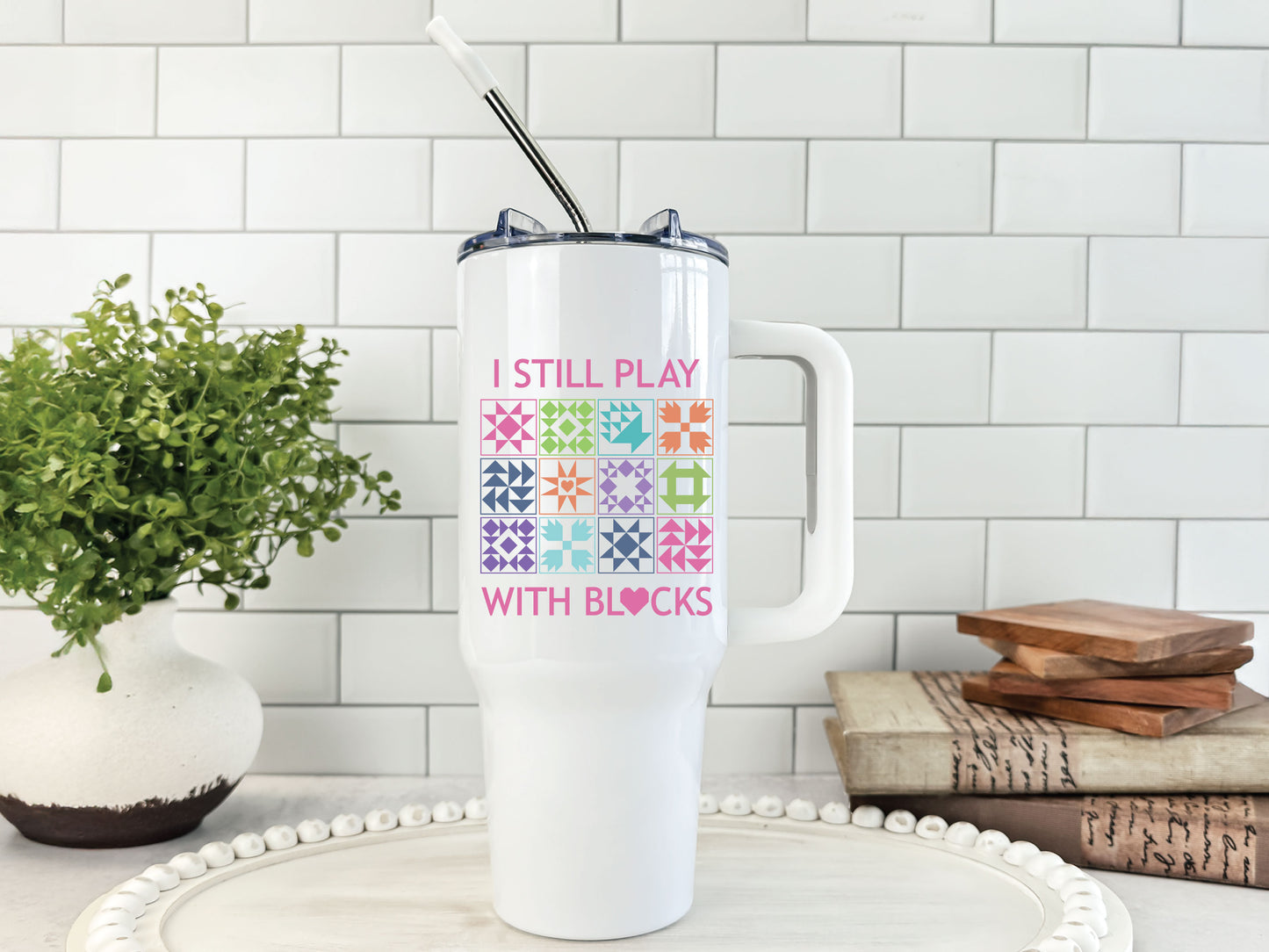 40oz tumbler with “I Still Play With Blocks,” decorated with colorful quilt blocks and a quilt-heart design; comes individually boxed for gifting.