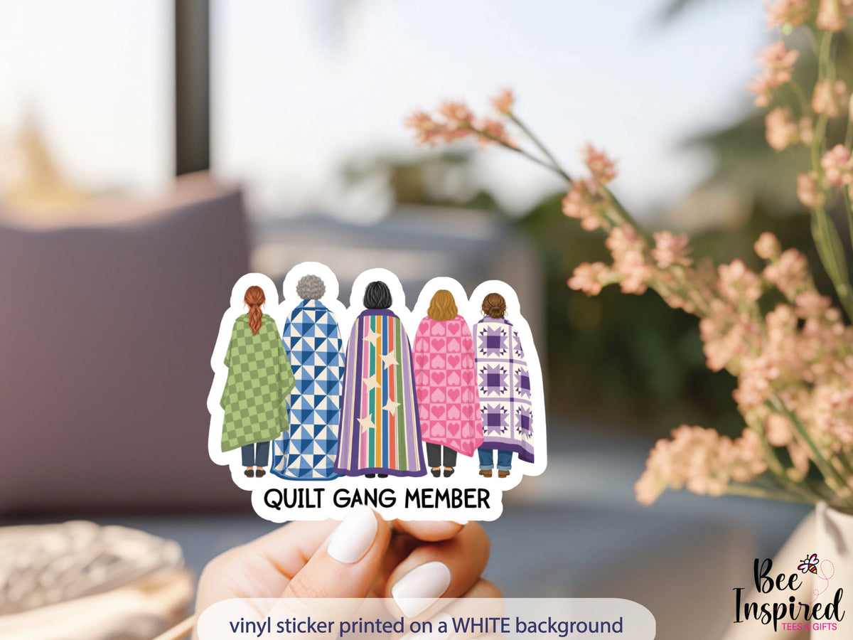 Quilt Gang Member sticker featuring five women standing together wrapped in colorful patterned quilts celebrating quilting friendship.