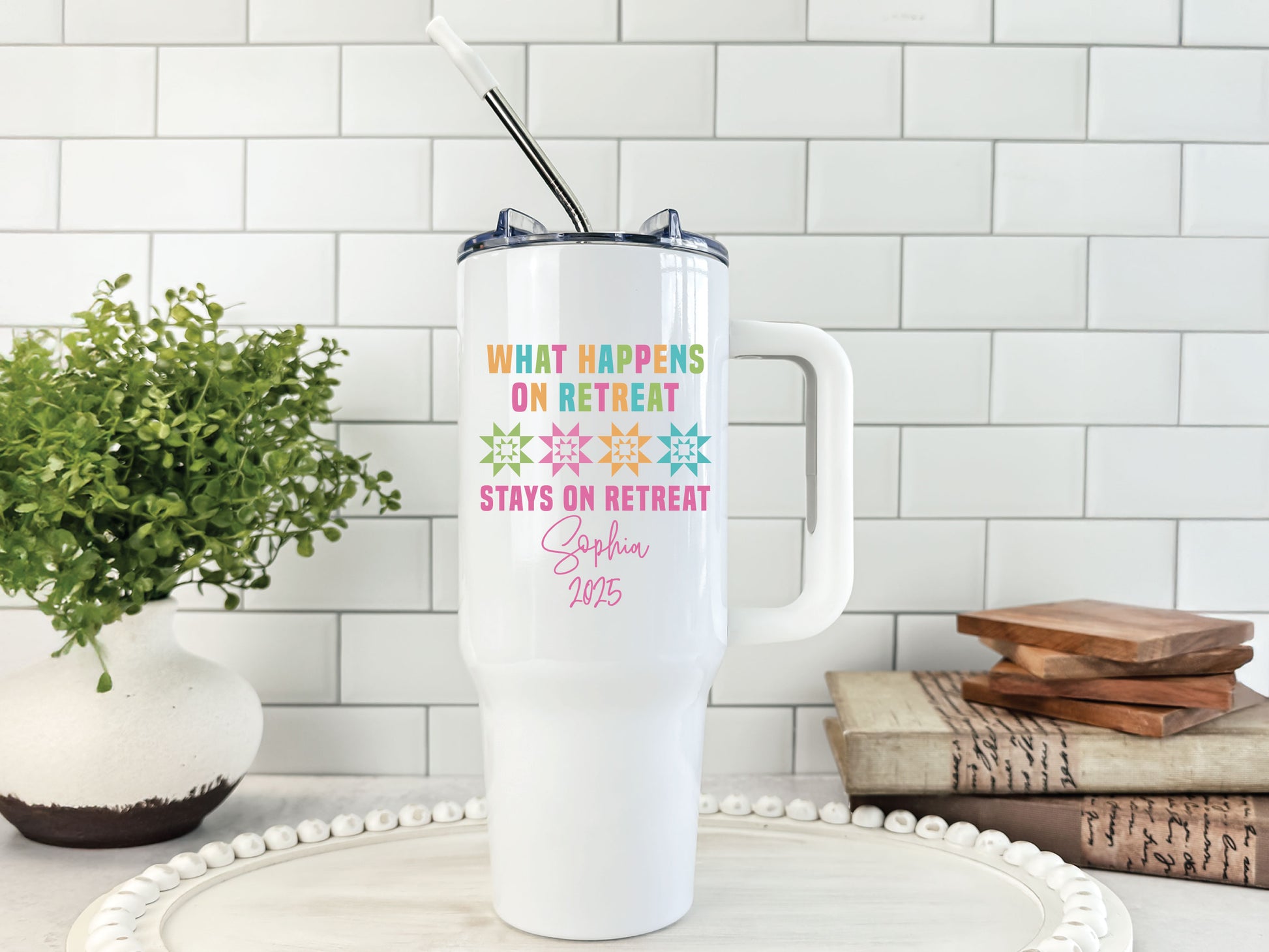 40oz stainless steel tumbler with “What Happens on Retreat Stays on Retreat,” colorful quilt blocks, and personalized name and year; a fun keepsake for quilters.