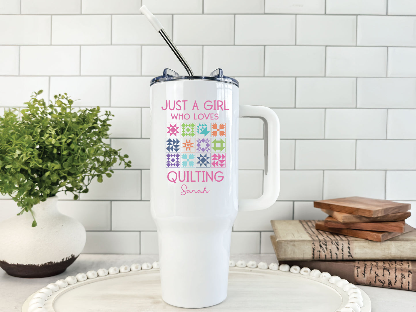 40oz stainless steel tumbler featuring “Just a Girl Who Loves Quilting” with colorful quilt blocks; personalized with your name and individually boxed for gifting.