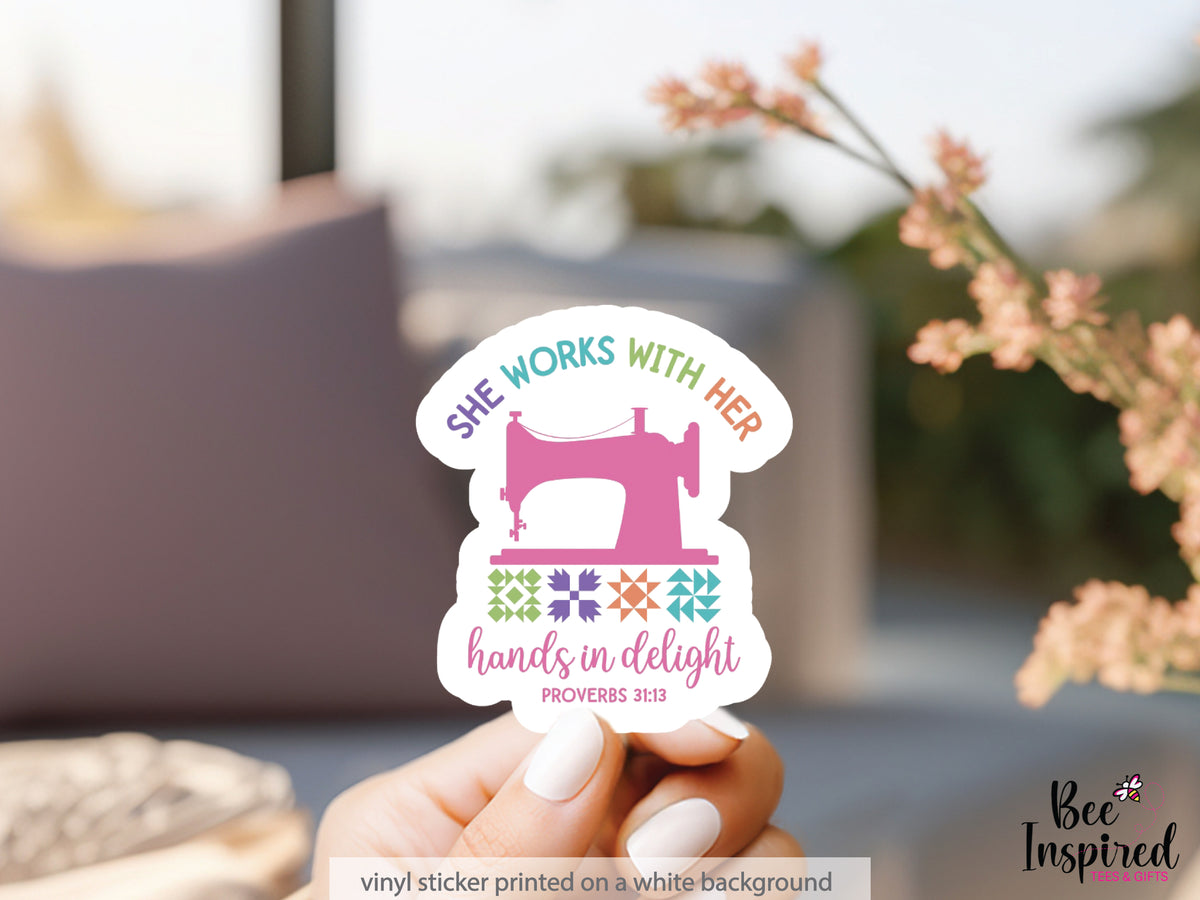She Works With Her Hands vinyl sticker featuring a vintage sewing machine, colorful quilt blocks, and the inspirational Proverbs 31:13 verse.