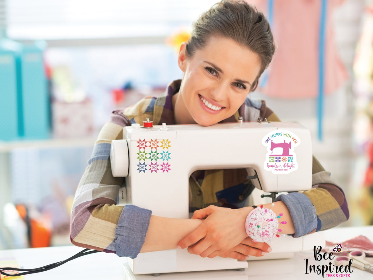 She Works With Her Hands vinyl sticker featuring a vintage sewing machine, colorful quilt blocks, and the inspirational Proverbs 31:13 verse.