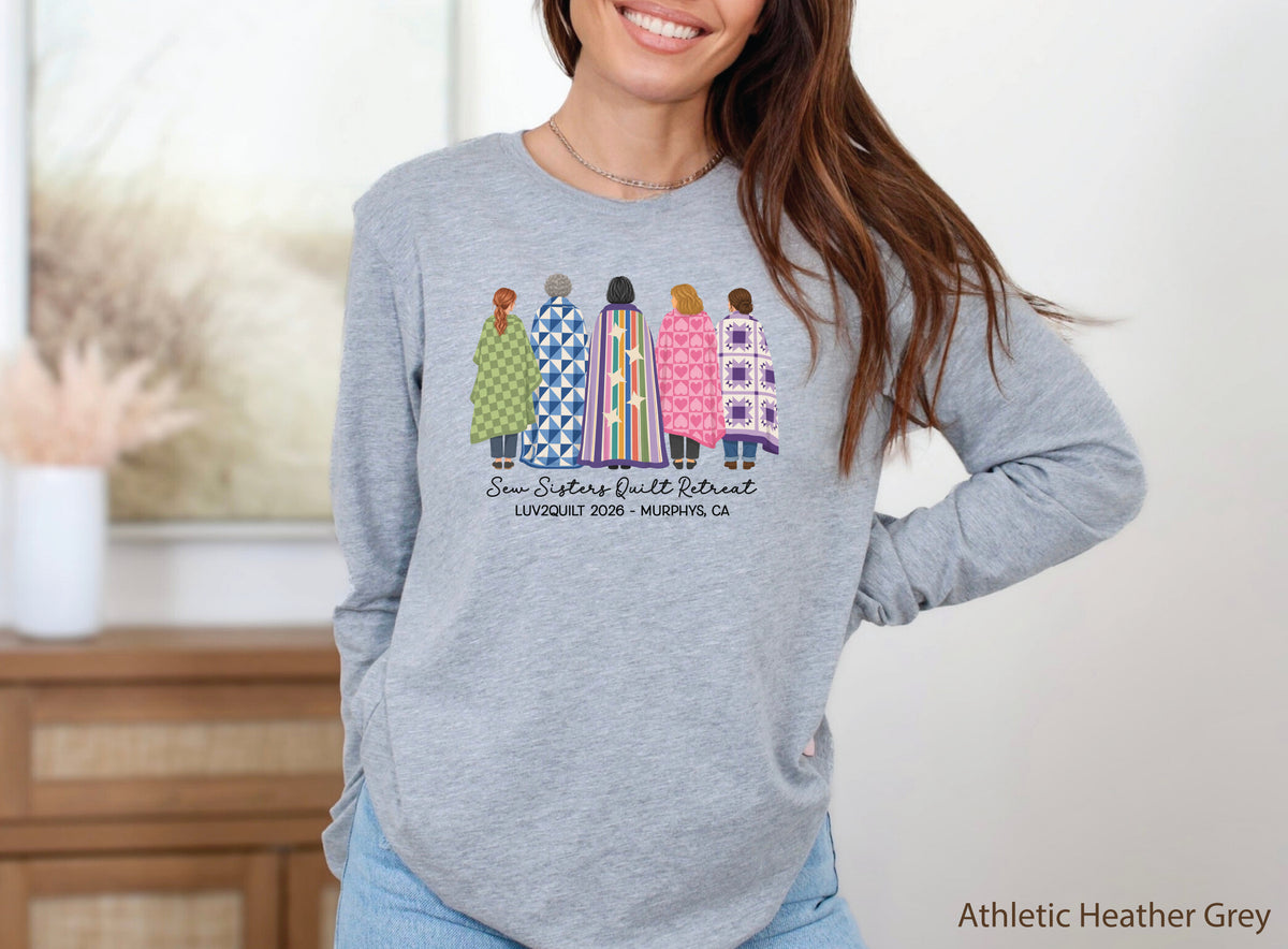 Sew Sisters Quilt Retreat long-sleeved shirt design featuring five women wrapped in colorful green, blue, striped, pink heart, and purple quilts with LUV2QUILT 2026 personalized text.