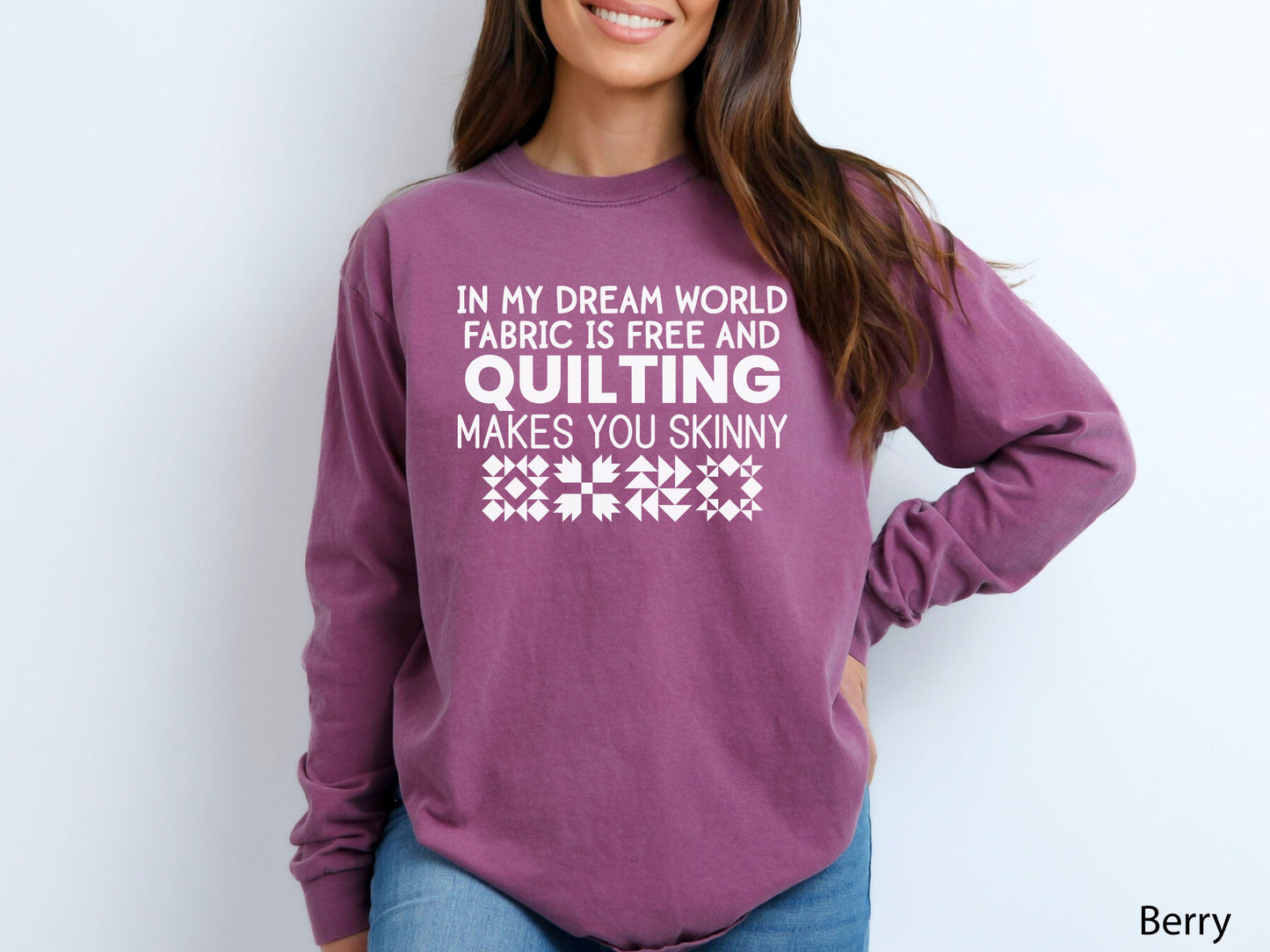 Funny quilter sweatshirt with the phrase “In My Dream World, Fabric Is Free and Quilting Makes You Skinny,” featuring quilt block designs and cozy long sleeves.