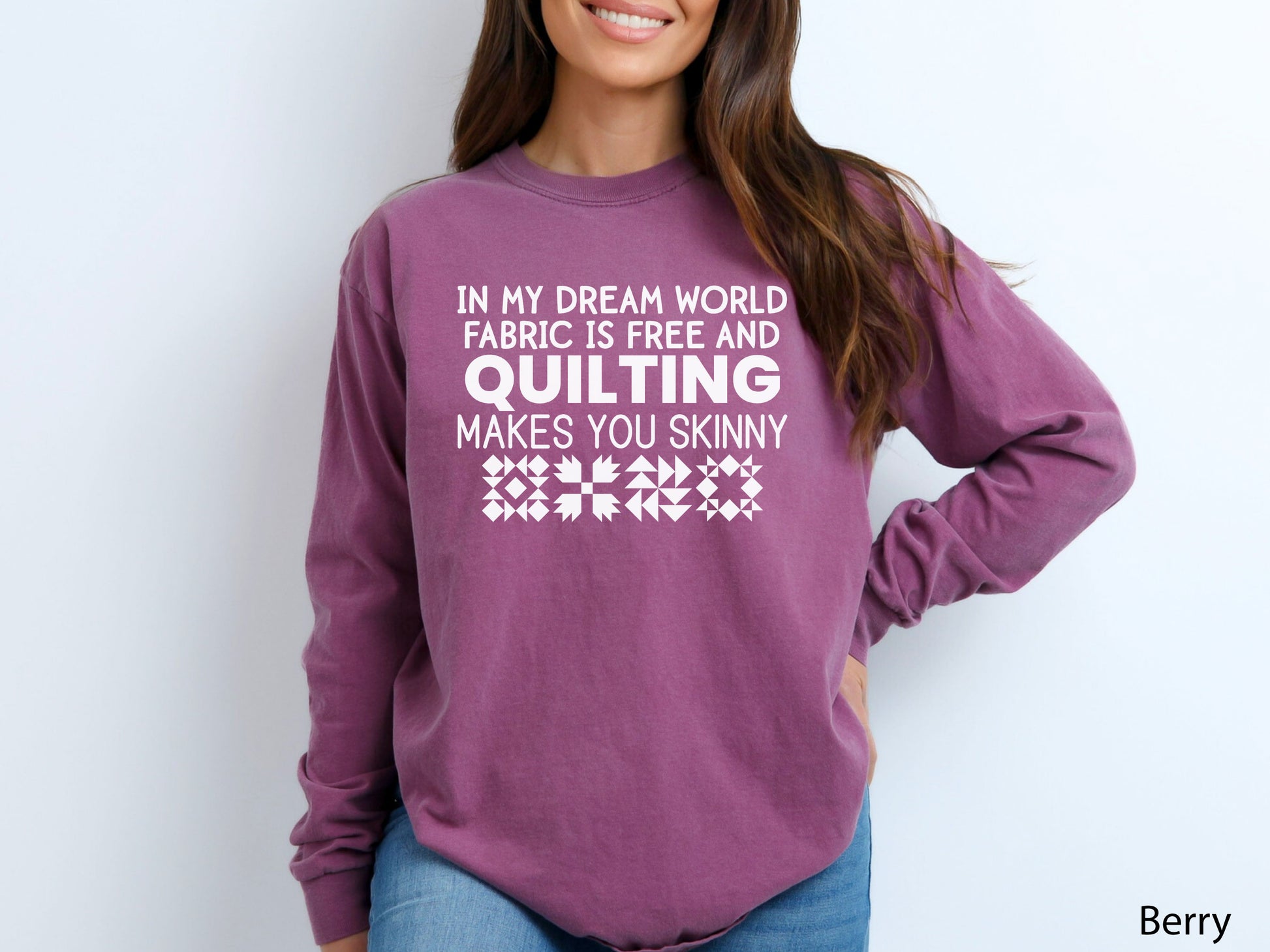Funny quilter sweatshirt with the phrase “In My Dream World, Fabric Is Free and Quilting Makes You Skinny,” featuring quilt block designs and cozy long sleeves.