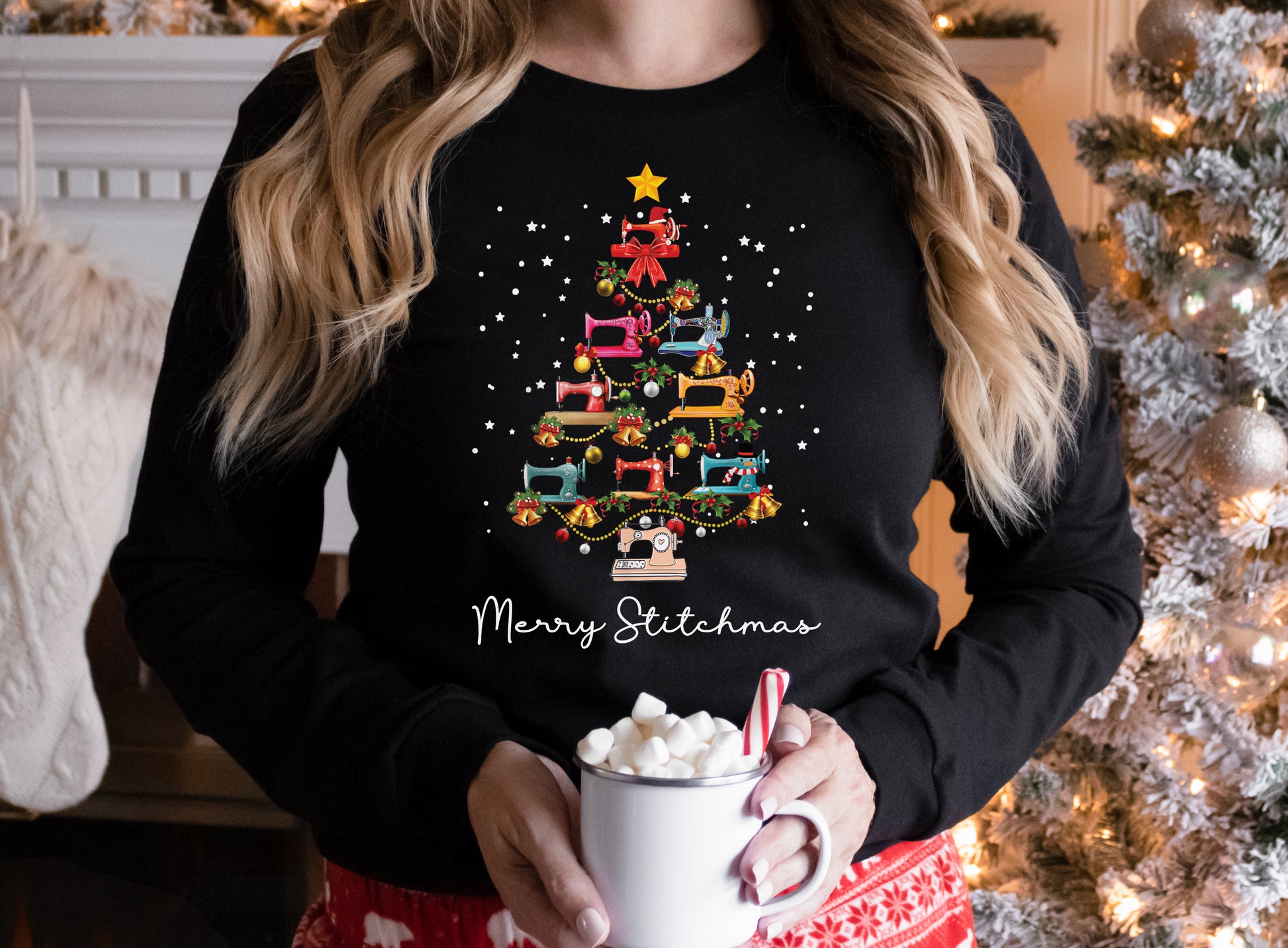 Black long sleeve shirt with a Christmas tree made of colorful sewing machines and the words “Merry Stitchmas” — festive holiday gift for quilters and sewists.