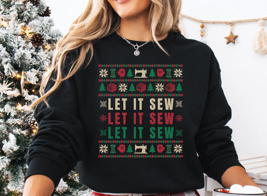 Black Christmas sweatshirt featuring a colorful knitted-style Let It Sew design with sewing machines, thread spools, fabric stacks, snowflakes, Christmas trees, and red and green quilt-inspired borders.