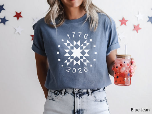 Patriotic quilting t-shirt in navy featuring a white star quilt block with surrounding stars and the years 1776–2026, celebrating America’s 250th Anniversary.