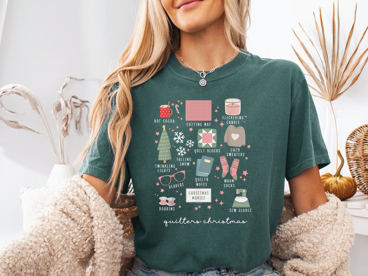 T-shirt with festive “Quilter’s Christmas” icons including quilt blocks, cocoa, lights, sweaters, and sewing items — perfect holiday gift for quilters and sewing lovers.