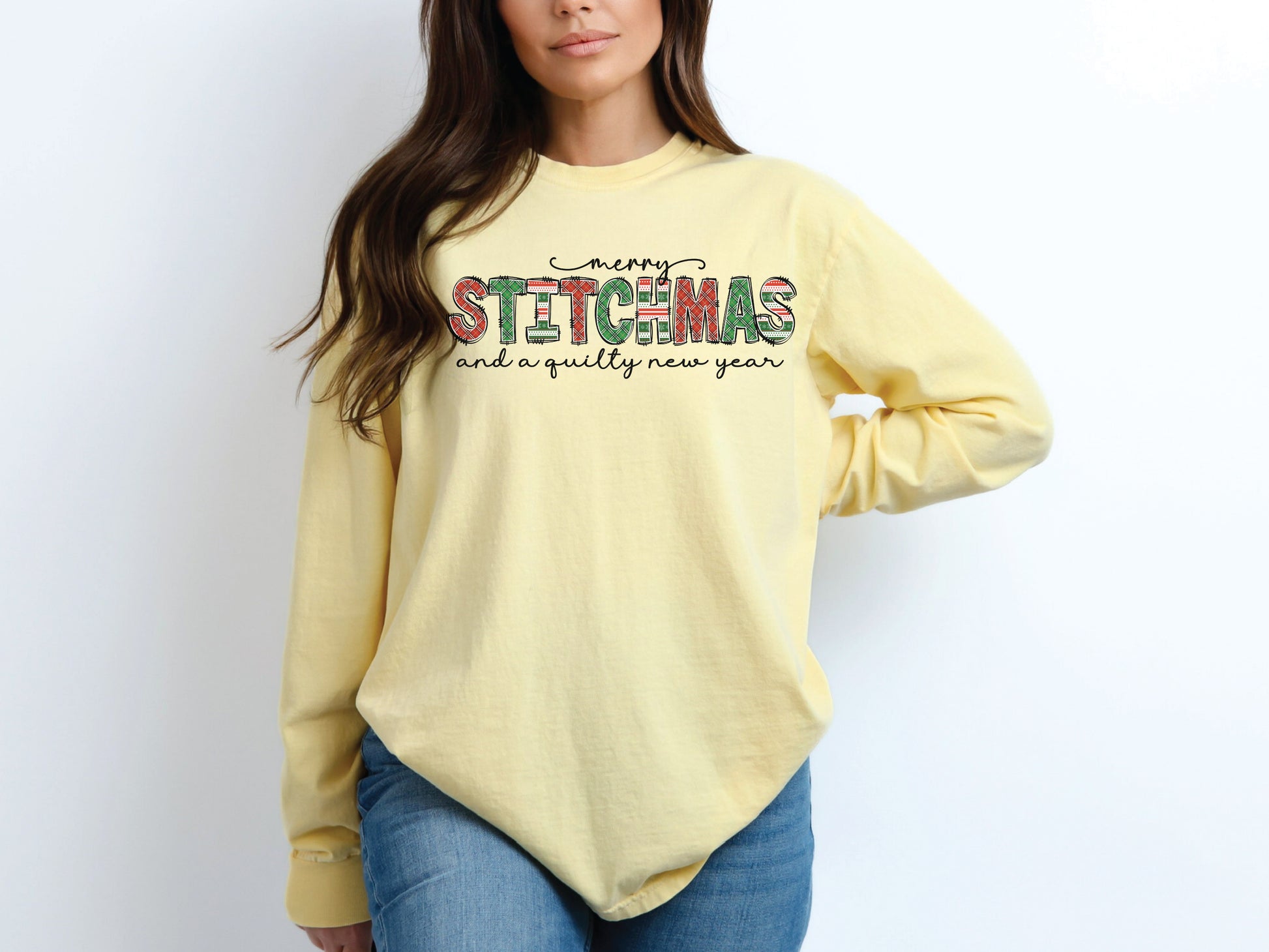 Festive Merry Stitchmas & a Quilty New Year t-shirt with red, green patchwork lettering—perfect holiday gift for quilters and sewists.