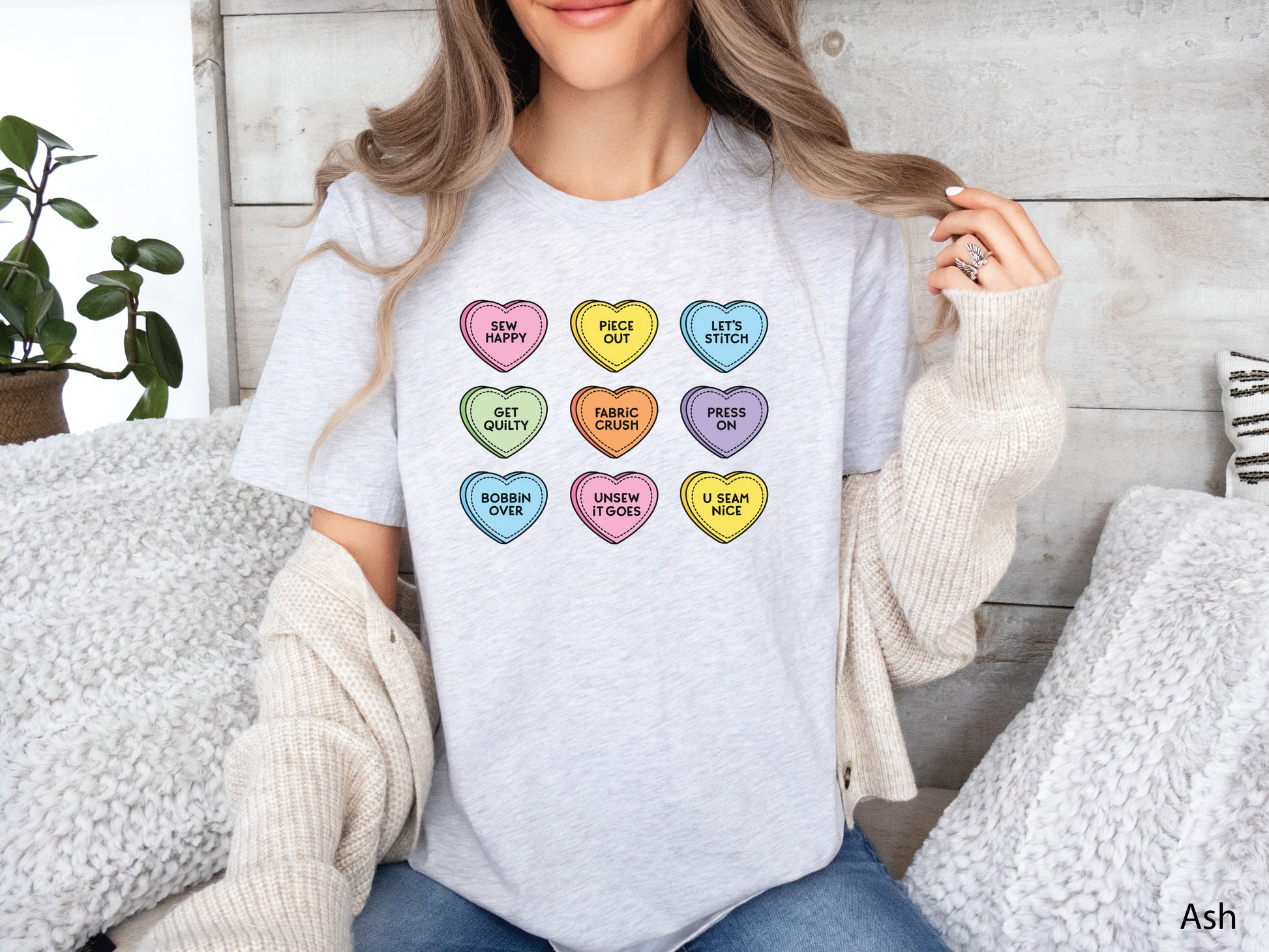 Valentine’s Day t-shirt with pastel conversation hearts and sewing phrases like “Sew Happy” and “Fabric Crush,” perfect for quilters and sewers.