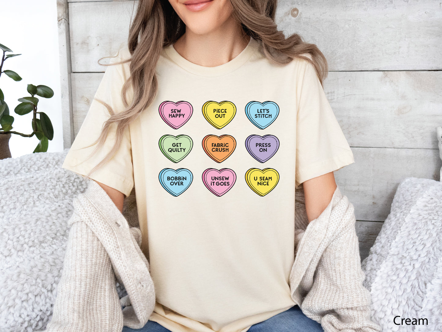 Valentine’s Day t-shirt with pastel conversation hearts and sewing phrases like “Sew Happy” and “Fabric Crush,” perfect for quilters and sewers.