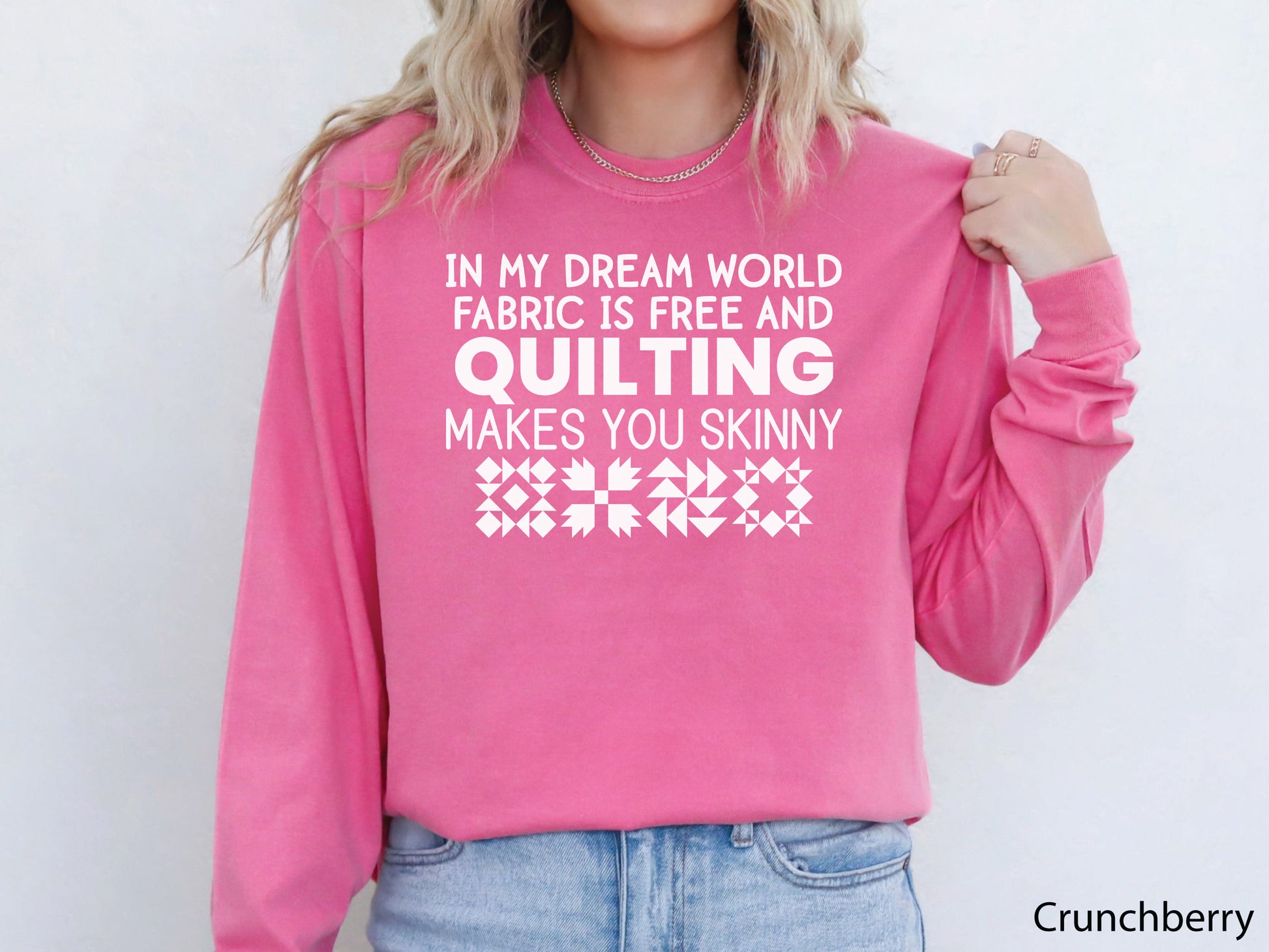Funny quilter sweatshirt with the phrase “In My Dream World, Fabric Is Free and Quilting Makes You Skinny,” featuring quilt block designs and cozy long sleeves.