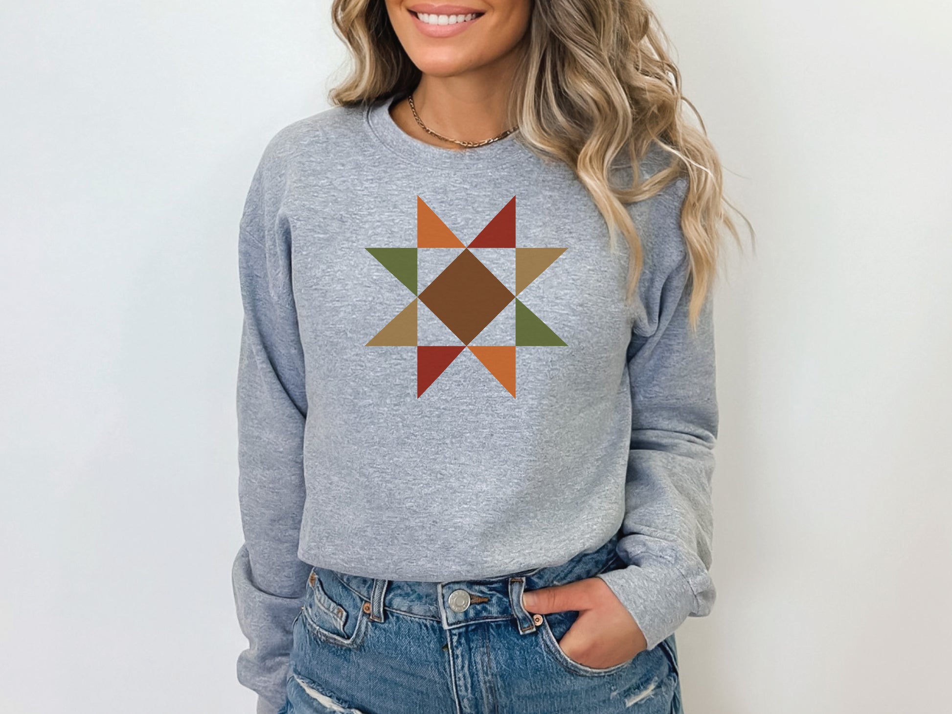 Evening Star quilt block sweatshirt in the color Sport Grey with autumn colors by Bee Inspired Tees. Gifts for Quilters, perfect for fall sewing, quilt retreats, and everyday wear.