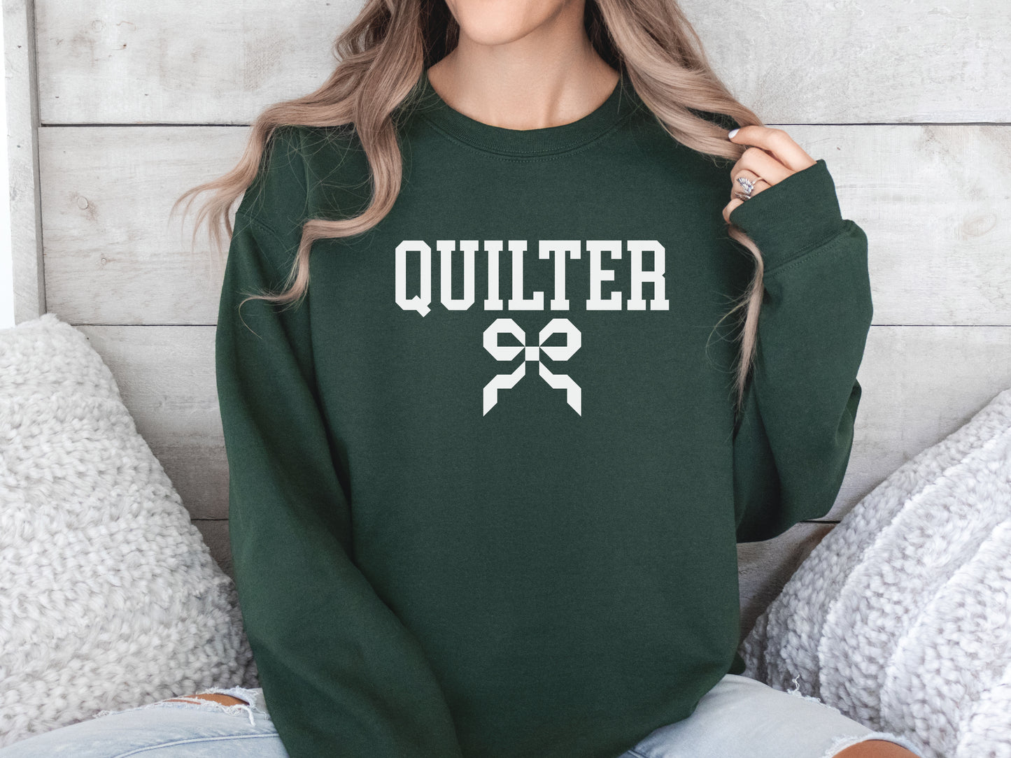 Quilter sweatshirt with varsity-style lettering and a quilty coquette bow, a cozy and stylish gift for quilters to wear at retreats, guilds, or while sewing at home.