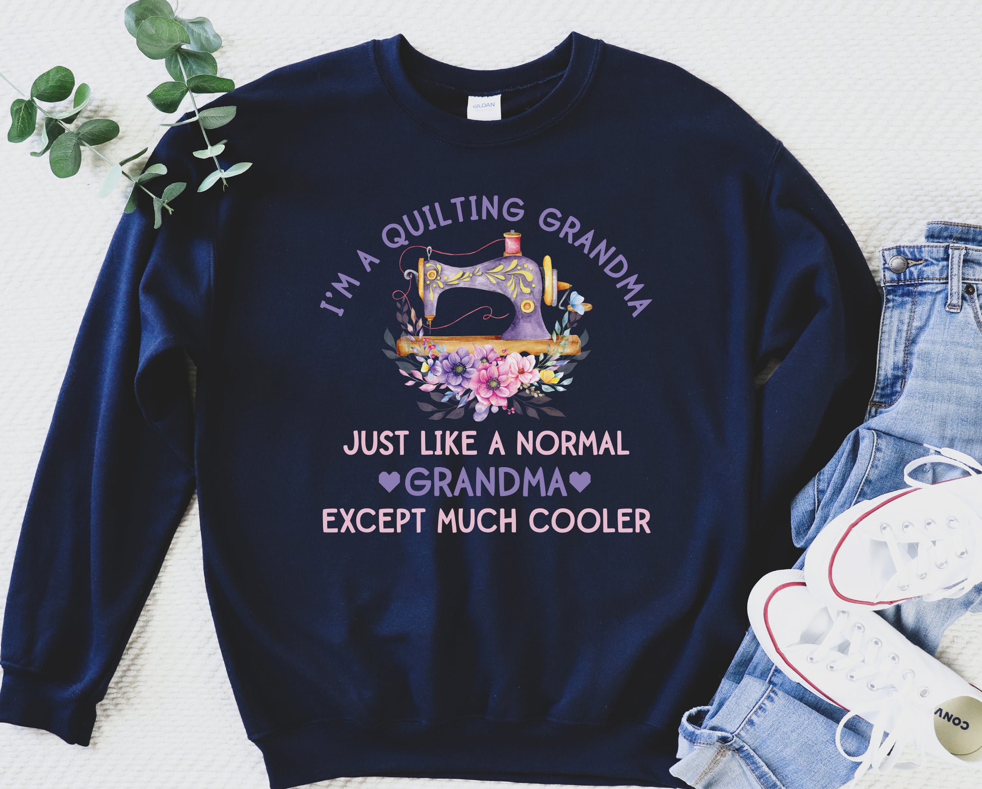 “I’m a Quilting Grandma” sweatshirt with floral sewing machine design and the phrase “Just Like a Normal Grandma Except Much Cooler.” Cozy gift for quilters from Bee Inspired Tees. 