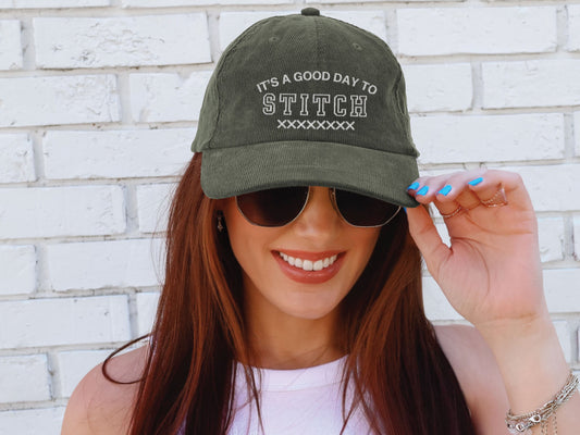 Vintage corduroy hat embroidered with the phrase “It’s a Good Day to Stitch,” shown in multiple color options—an ideal gift for cross stitch, embroidery, and needlework lovers.