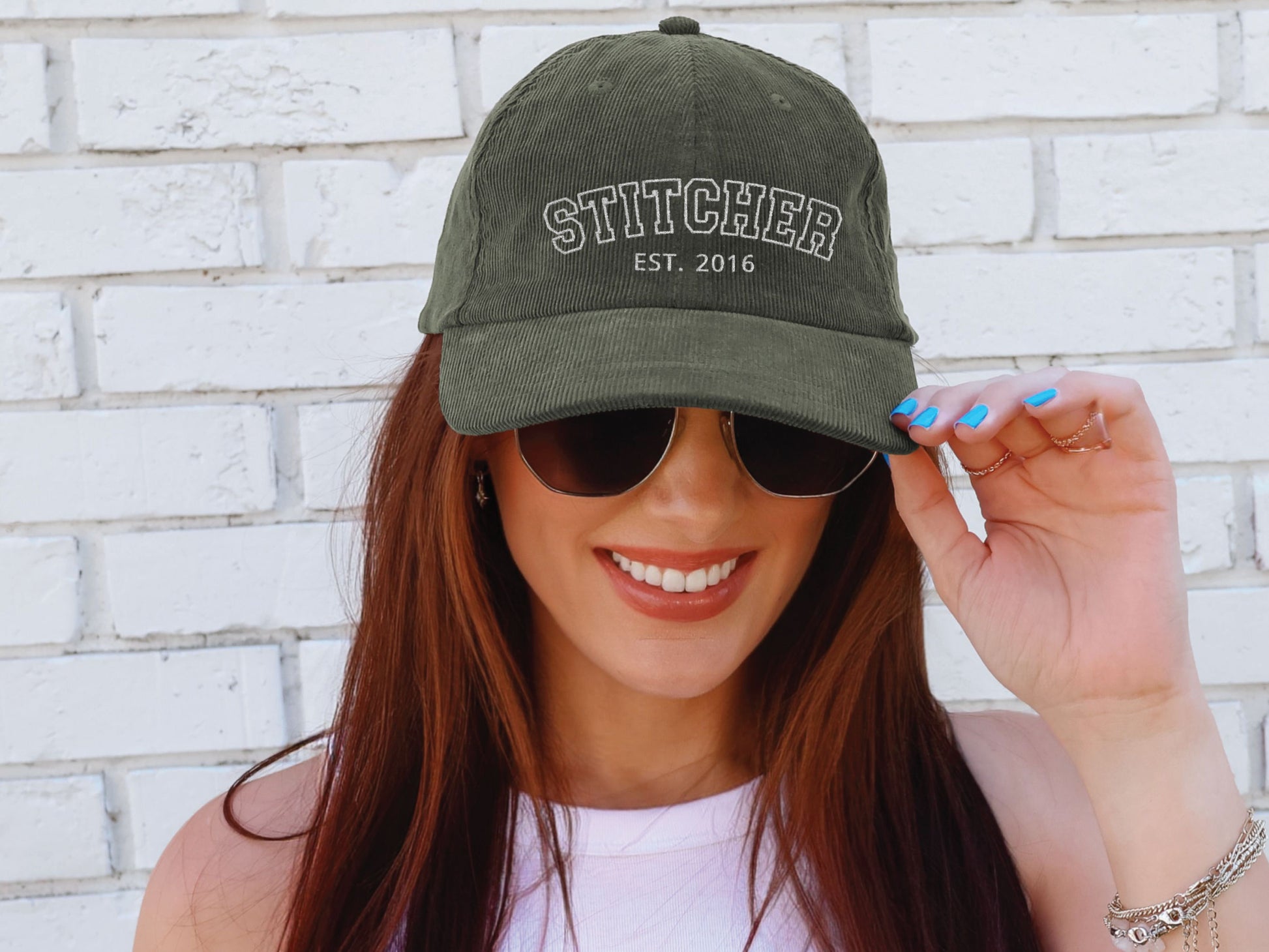 Vintage corduroy hat embroidered with “STITCHER,” personalized with the stitcher’s start year, shown in multiple color options—ideal gift for cross stitch, embroidery, and needlepoint enthusiasts.