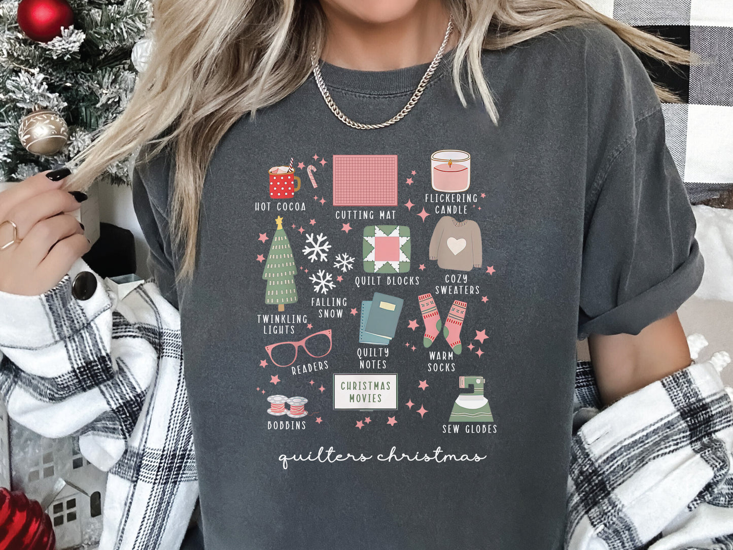 T-shirt with festive “Quilter’s Christmas” icons including quilt blocks, cocoa, lights, sweaters, and sewing items — perfect holiday gift for quilters and sewing lovers.