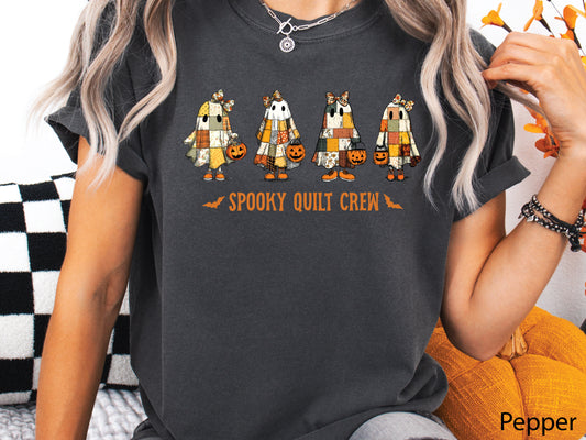 Spooky Quilt Crew Comfort Colors  t-shirt from Bee Inspired Tees in Pepper (dark grey), featuring four patchwork ghosts with jack-o’-lanterns and bold text—fun Halloween gift for quilters.