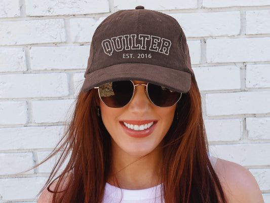 Vintage corduroy hat embroidered with “QUILTER,” personalized with the quilter’s start year, shown in multiple color options—an ideal gift for quilting lovers and sewing enthusiasts.