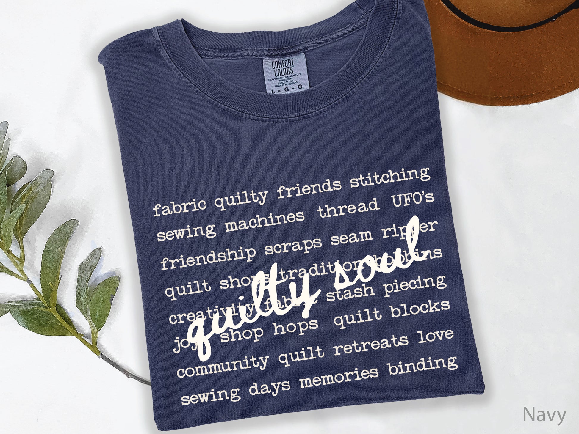 Vintage-inspired Quilty Soul t-shirt featuring a typewriter-style mix of quilting words with flowing handwritten script, perfect for quilters, everyday wear, quilt retreats, Halloween, and spooky season.