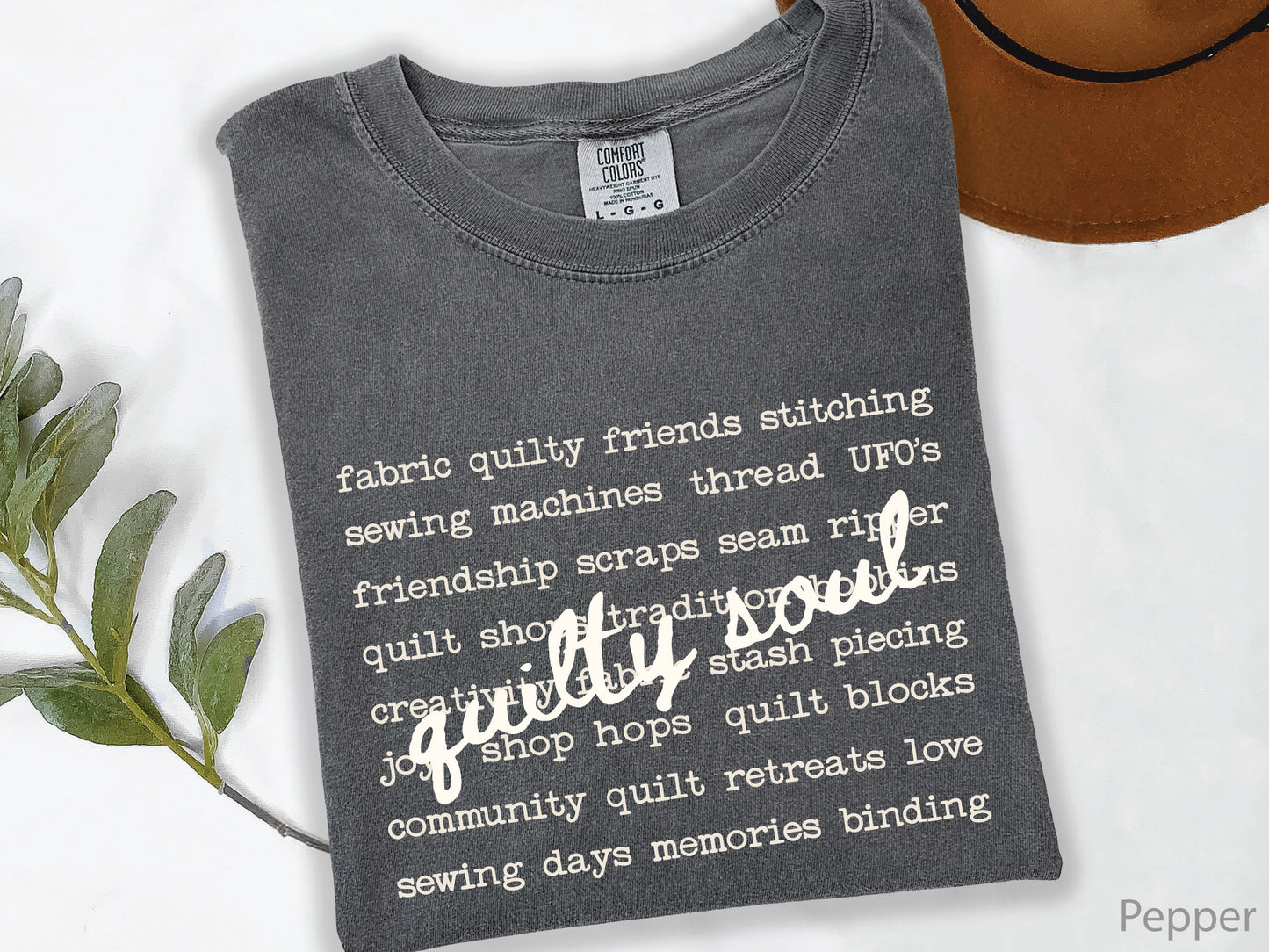 Vintage-inspired Quilty Soul t-shirt featuring a typewriter-style mix of quilting words with flowing handwritten script, perfect for quilters, everyday wear, quilt retreats, Halloween, and spooky season.