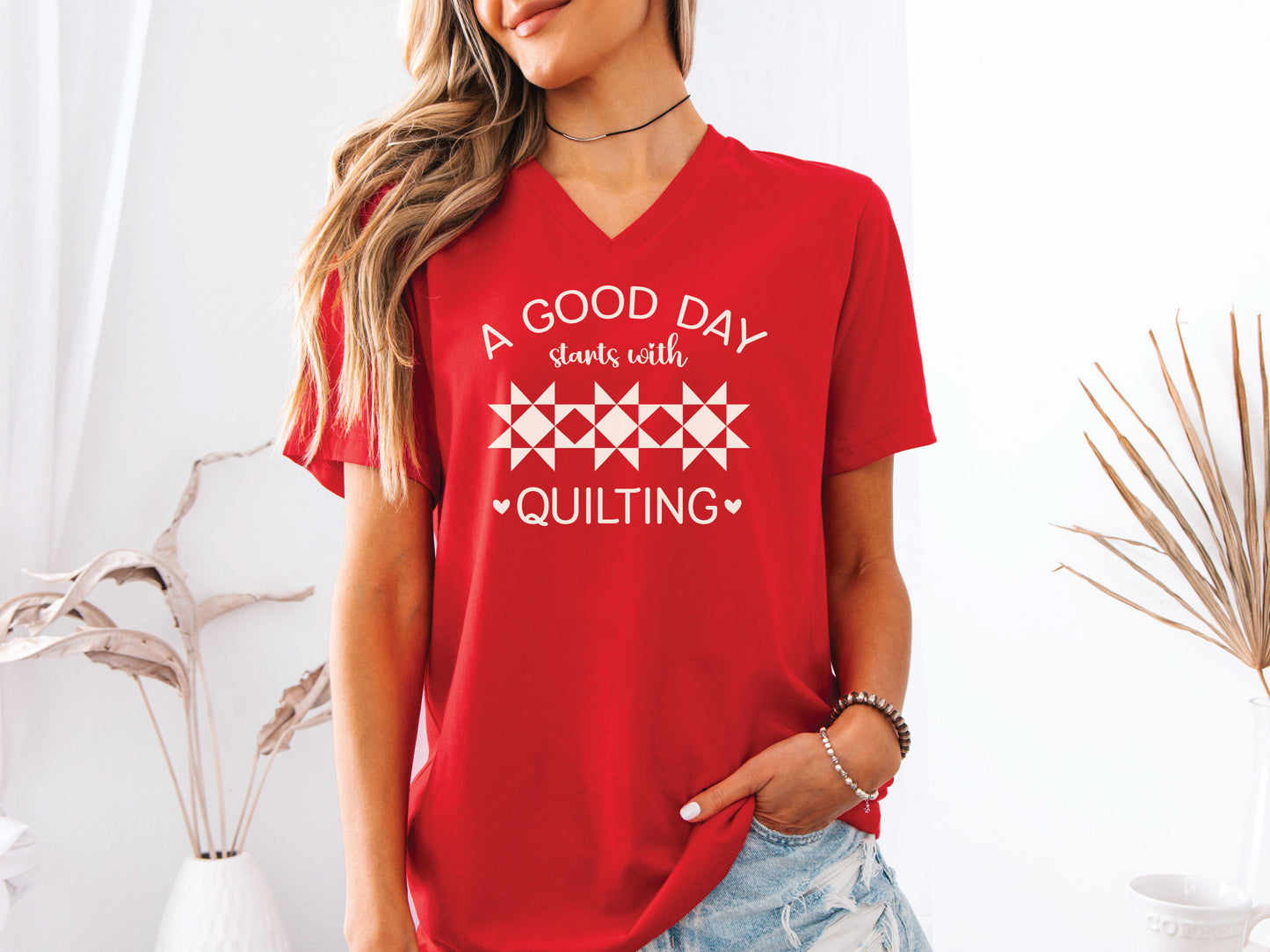 A Good Day Starts With Quilting” T-shirt on a soft red V-neck — a fun gift for sewing and quilting lovers, celebrating every stitch, even with a seam ripper.