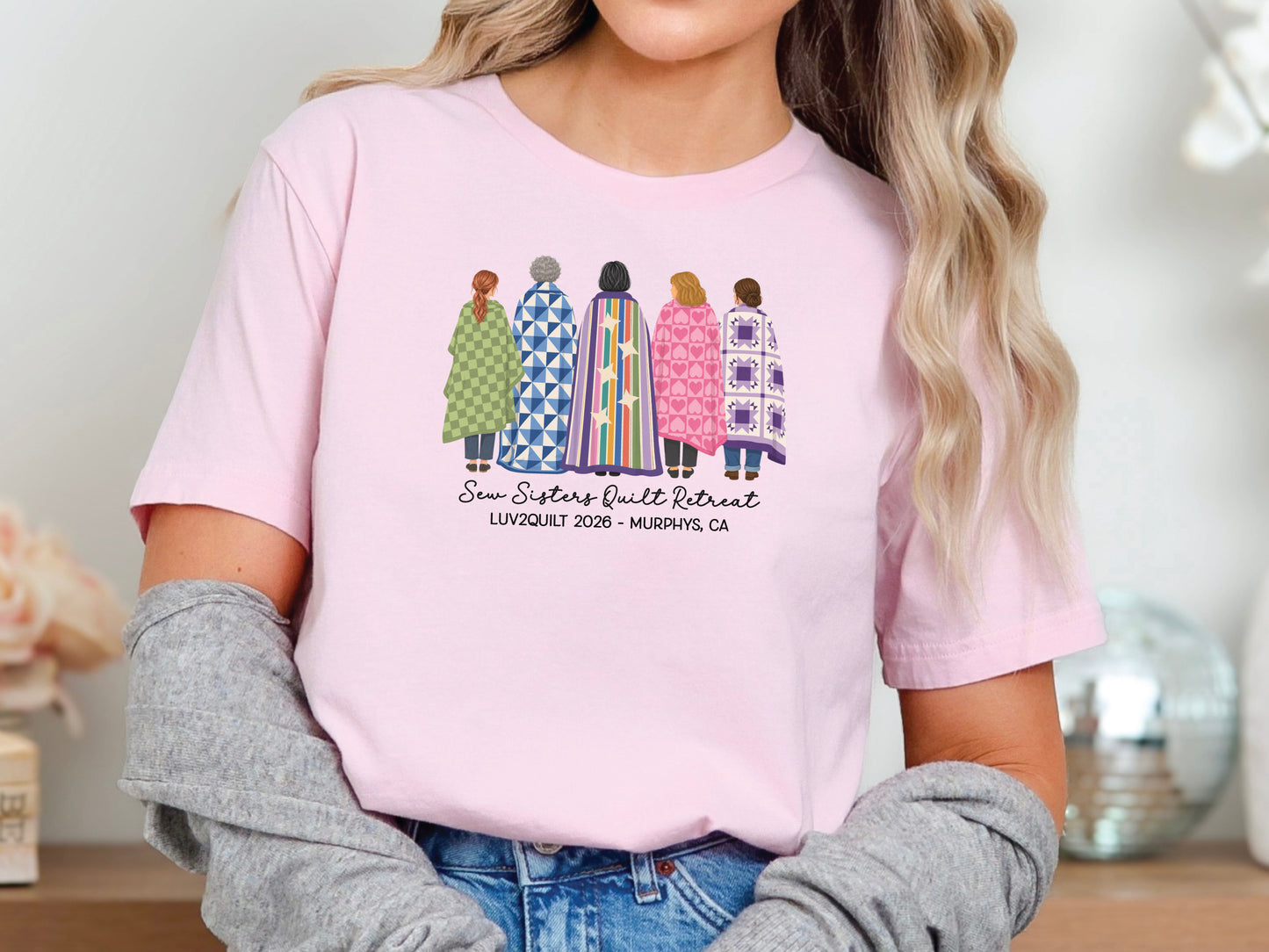 Sew Sisters Quilt Retreat shirt design featuring five women wrapped in colorful green, blue, striped, pink heart, and purple quilts with personalized text.