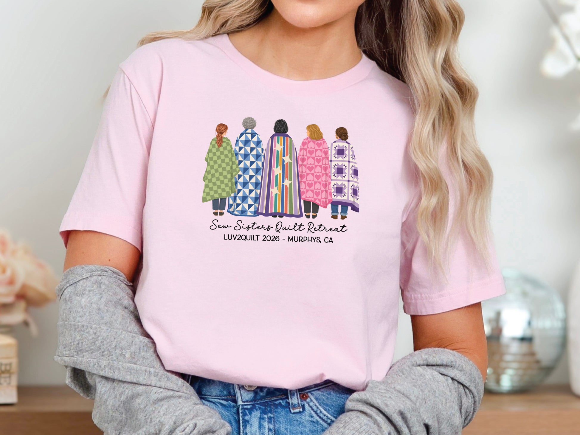 Sew Sisters Quilt Retreat shirt design featuring five women wrapped in colorful green, blue, striped, pink heart, and purple quilts with personalized text.