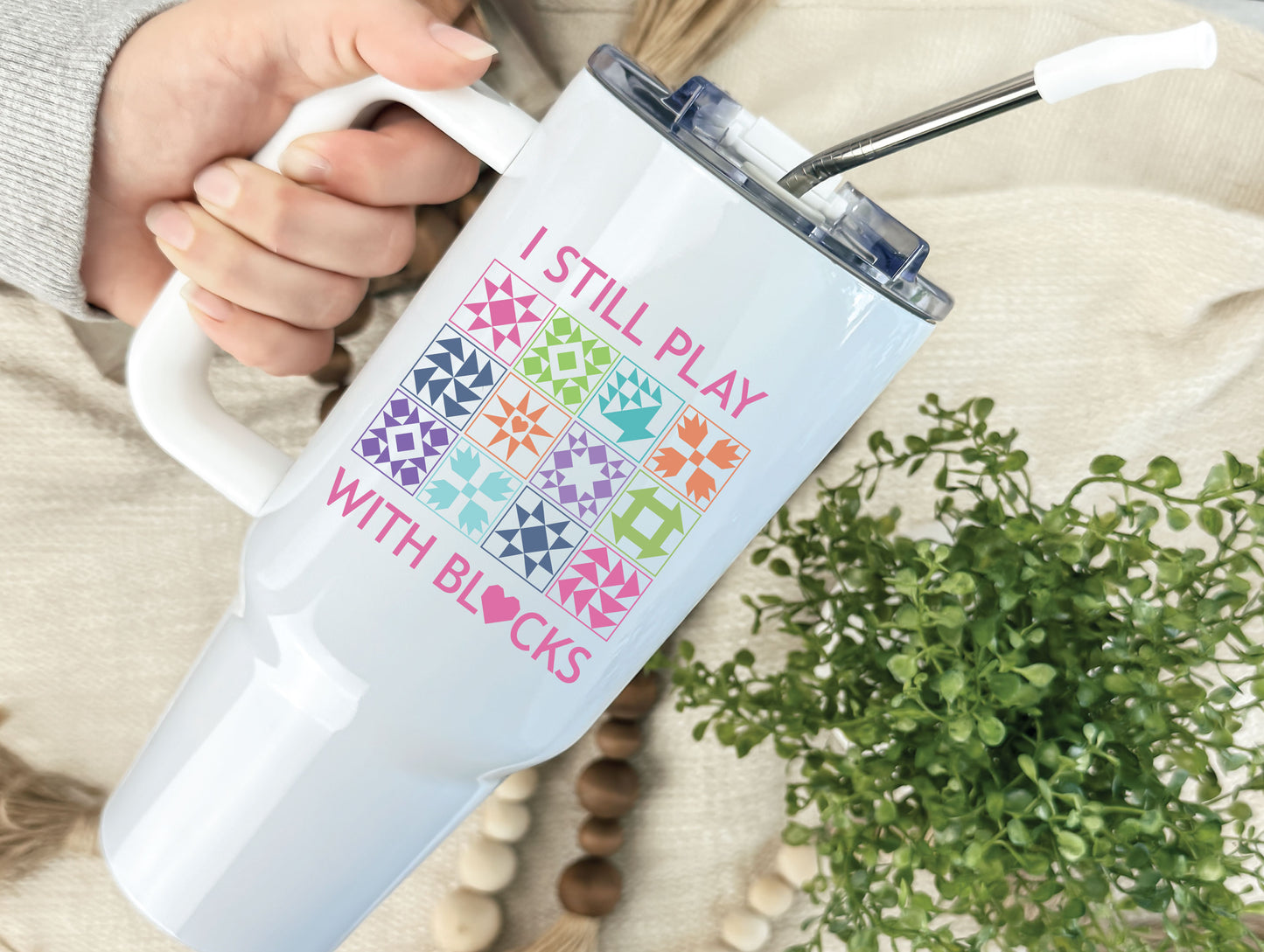 40oz tumbler with “I Still Play With Blocks,” decorated with colorful quilt blocks and a quilt-heart design; comes individually boxed for gifting.