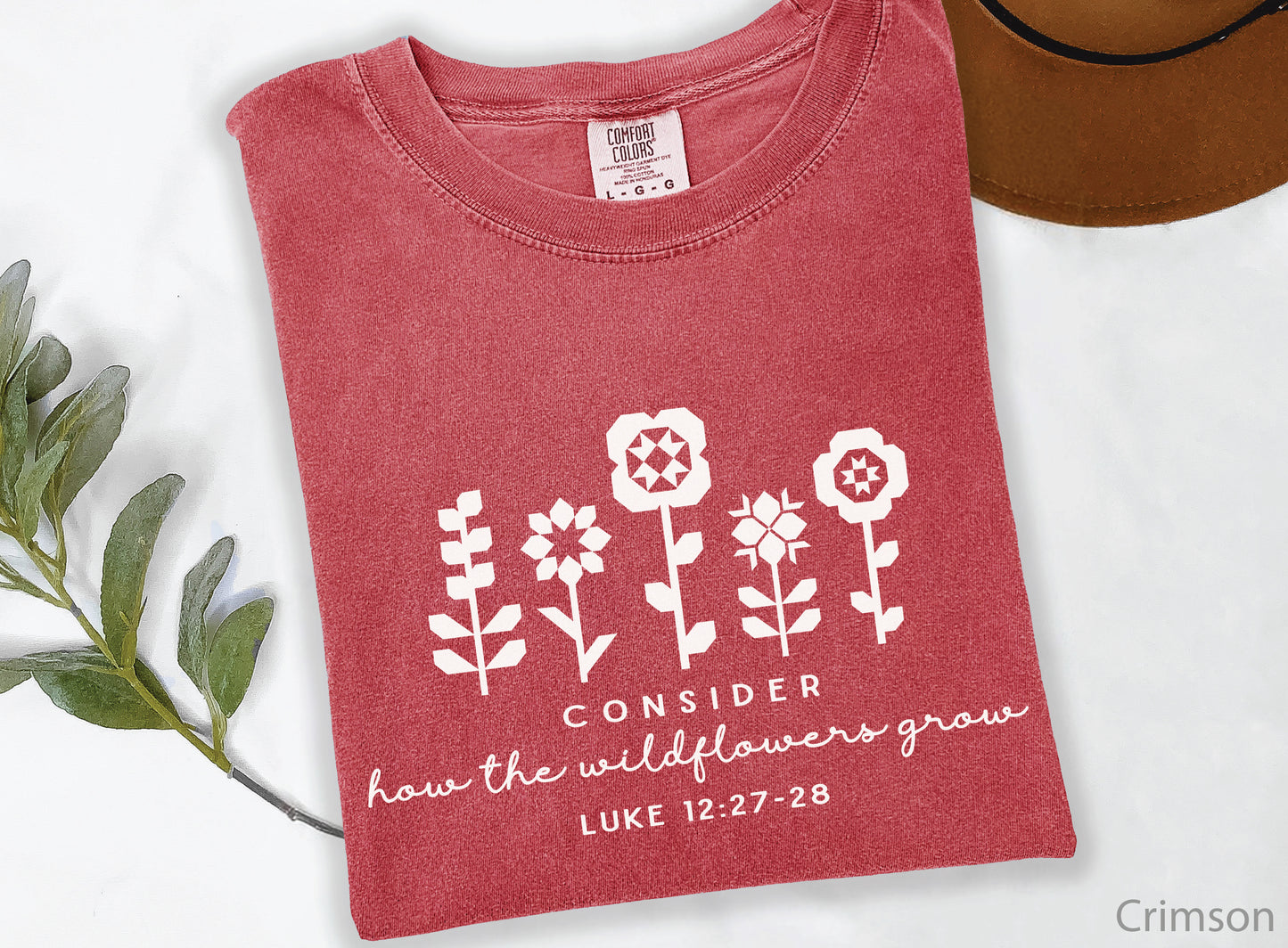Quilt-inspired wildflower design t-shirt featuring Bible verse Luke 12:27–28, perfect for quilters and faith-based apparel.
