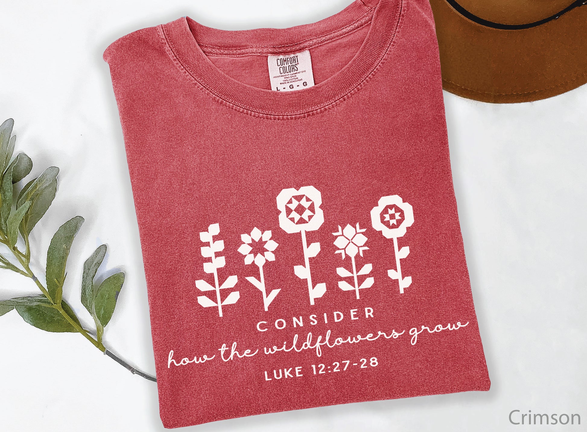 Quilt-inspired wildflower design t-shirt featuring Bible verse Luke 12:27–28, perfect for quilters and faith-based apparel.