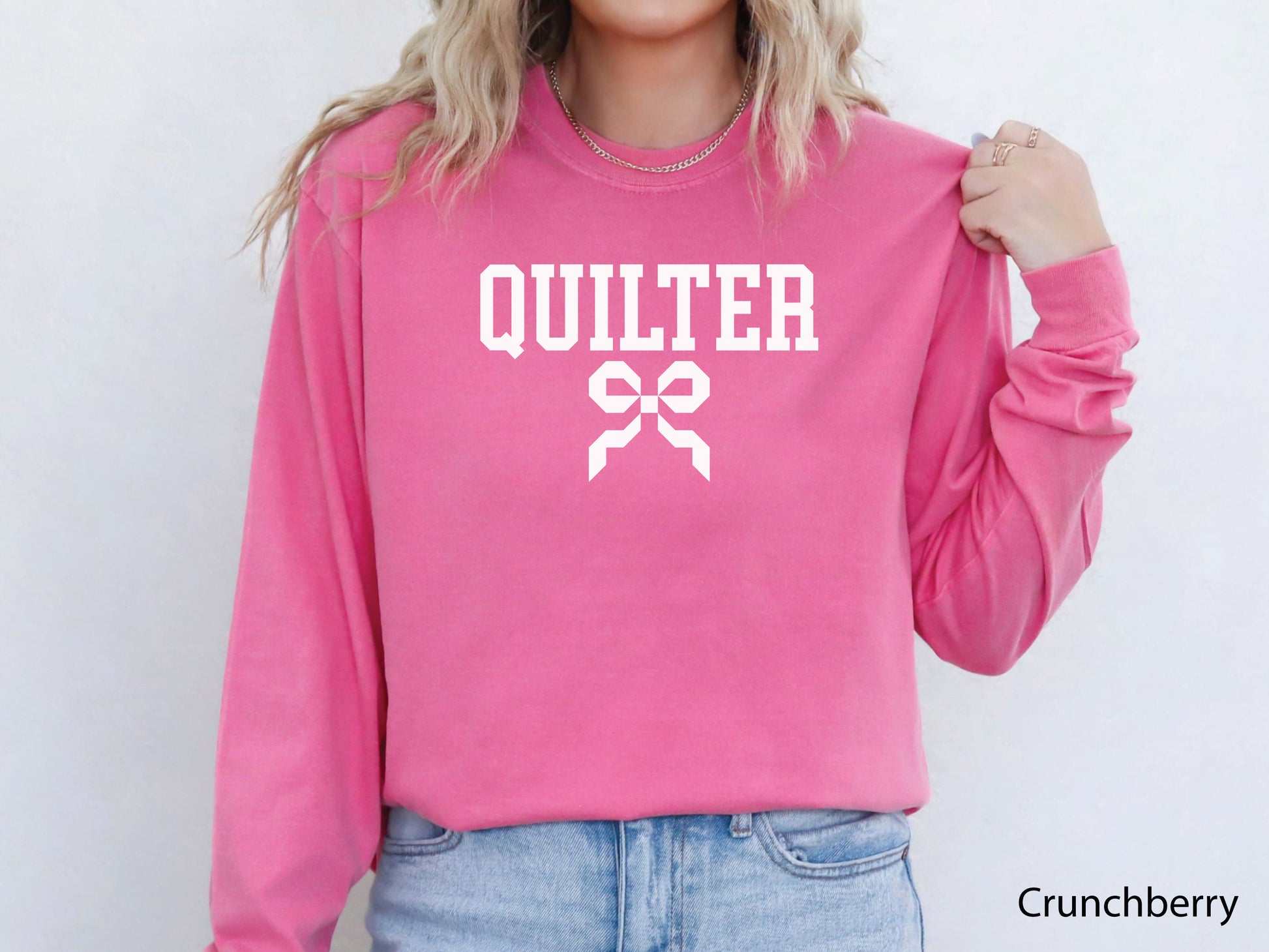 Cozy sweatshirt with bold varsity-style “Quilter” lettering and a coquette bow — perfect for quilt retreats, guild meetings, or as a thoughtful gift for quilters.